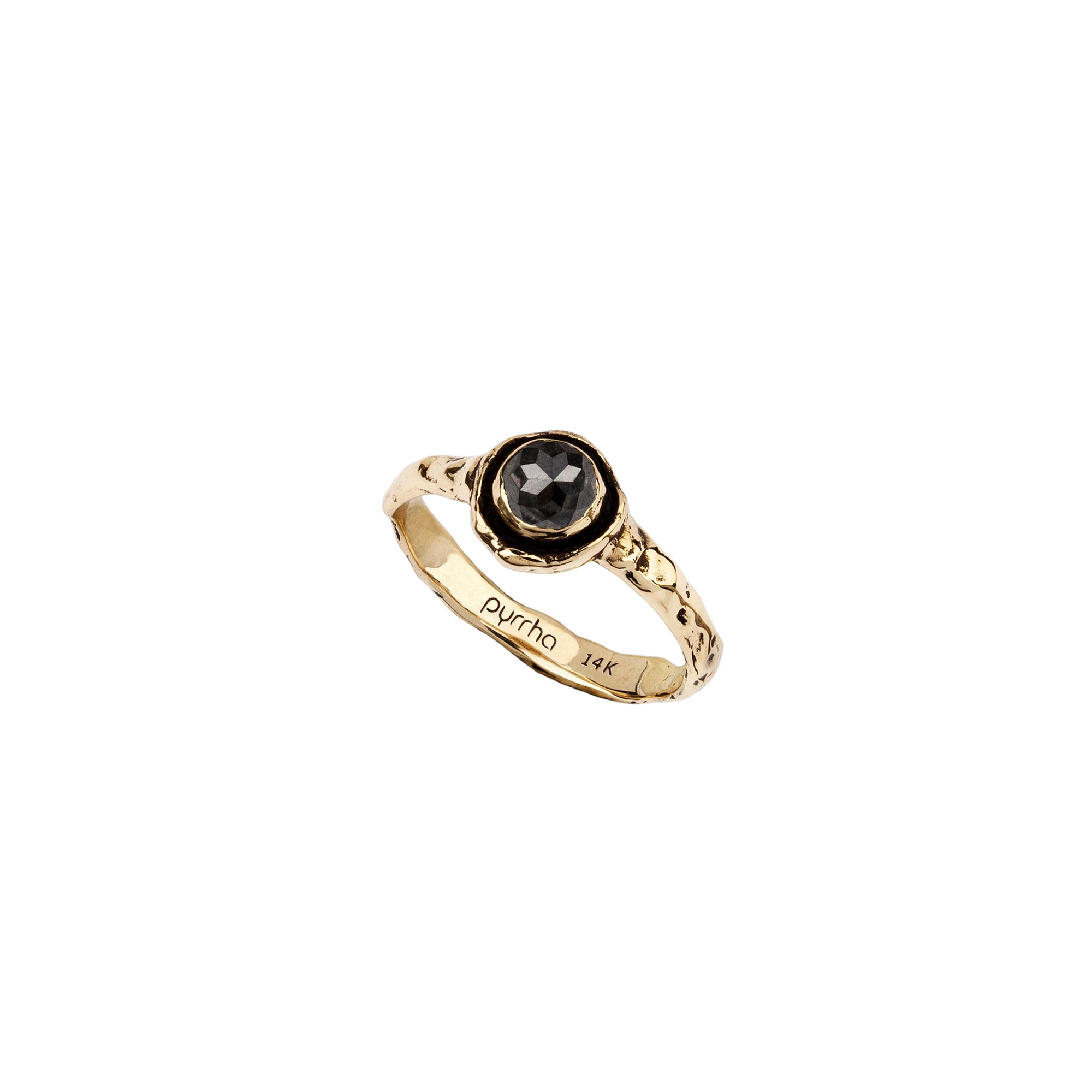 A narrow 14k gold ring set with a charcoal diamond.