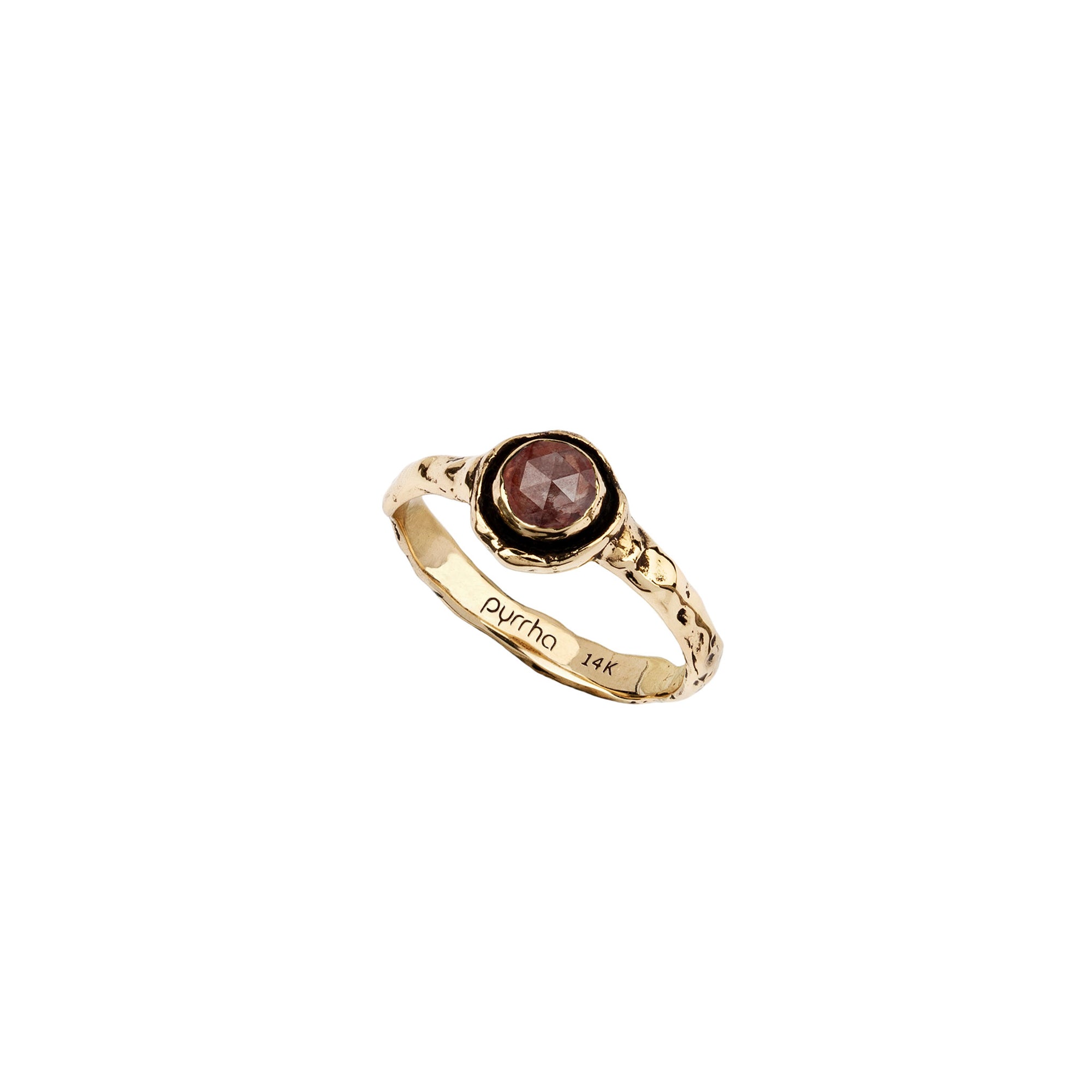 A narrow 14k gold ring set with a cognac diamond.