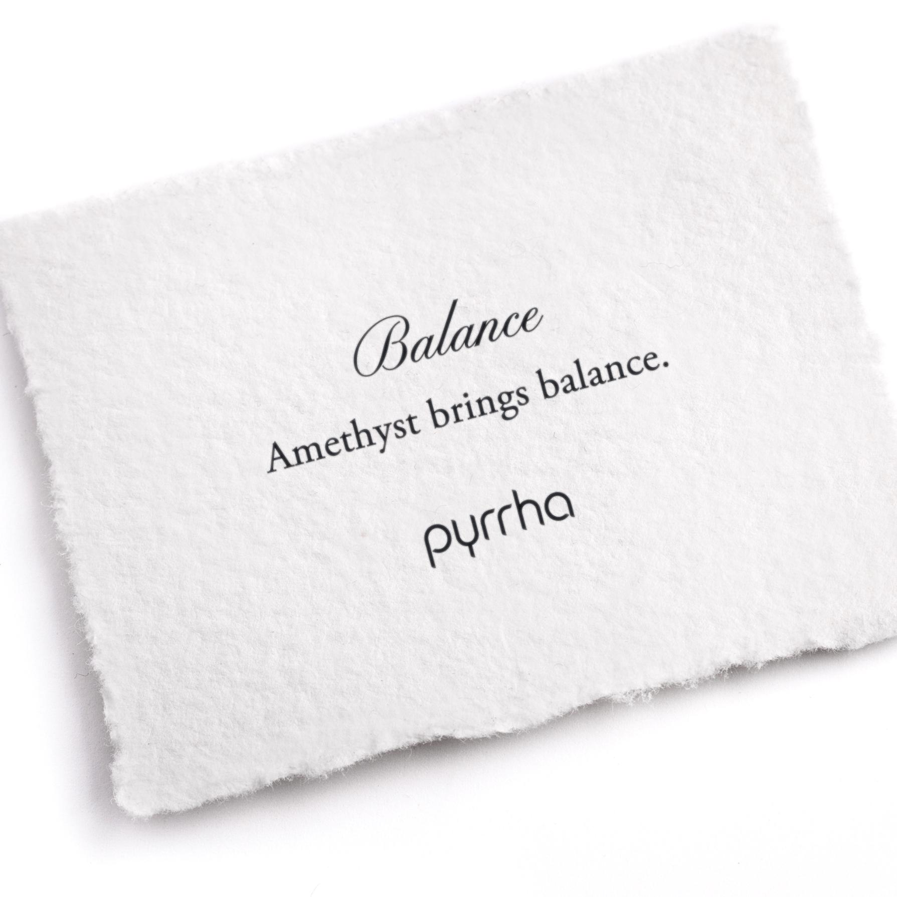 A hand-torn, letterpress printed card describing the meaning for Pyrrha's Balance Attraction Charm