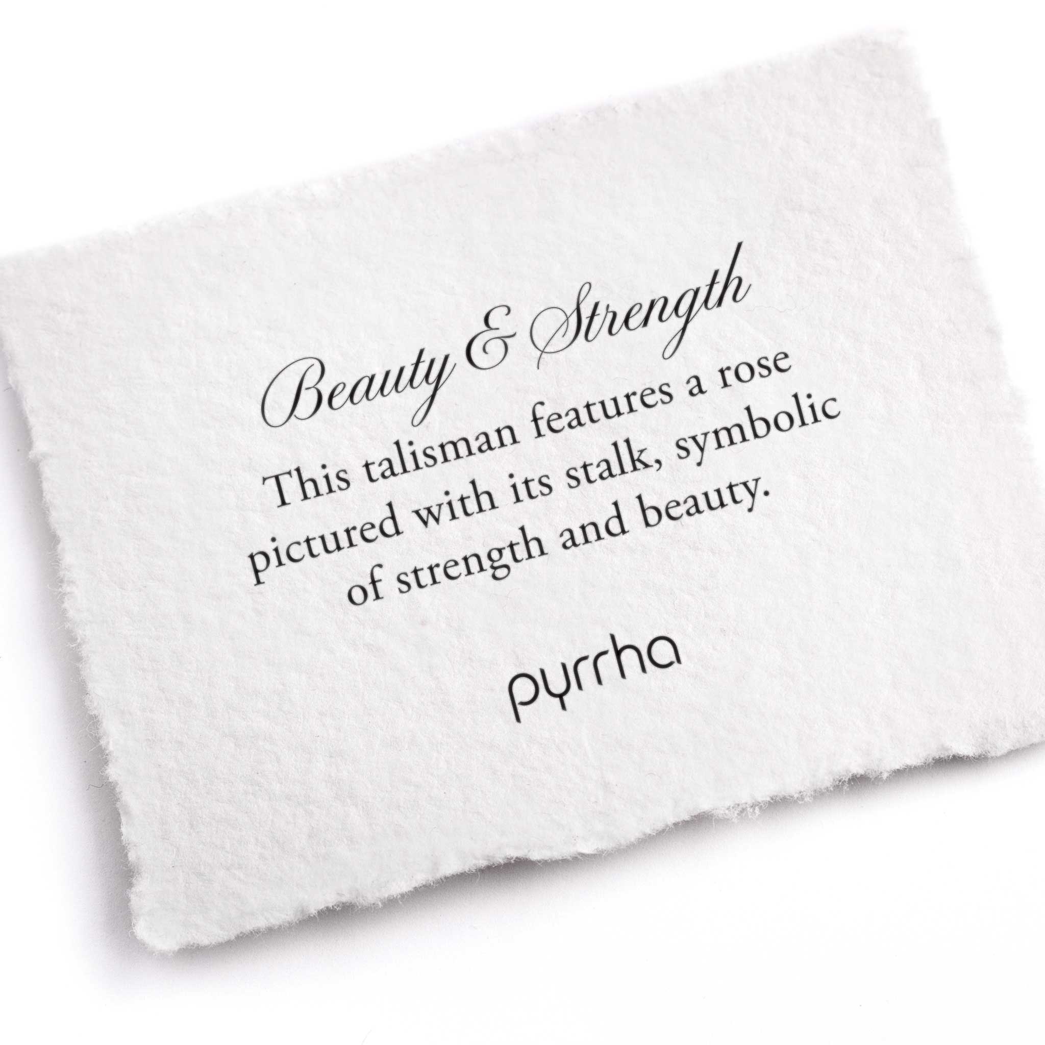 A hand-torn, letterpress printed card describing the meaning for Pyrrha's Beauty & Strength Talisman