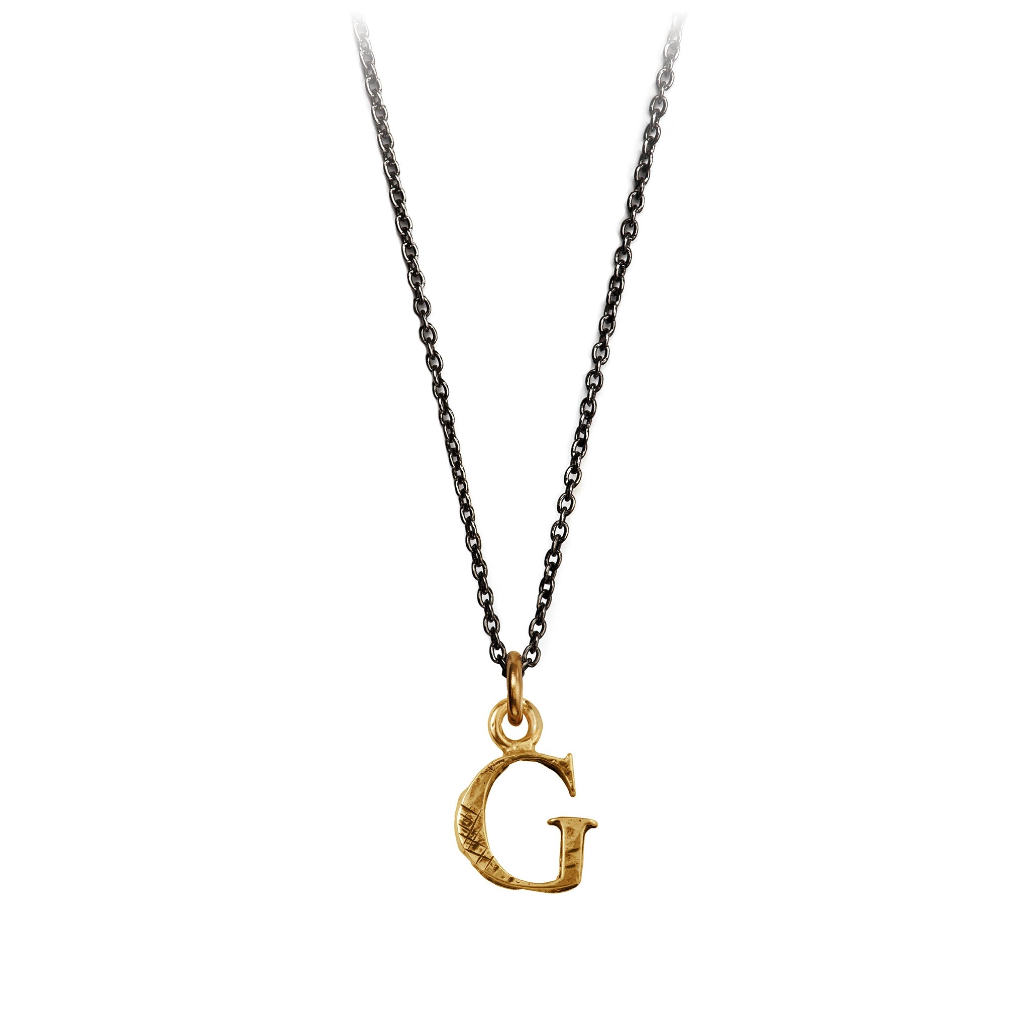 A bronze "G" charm on a blackened sterling silver chain.