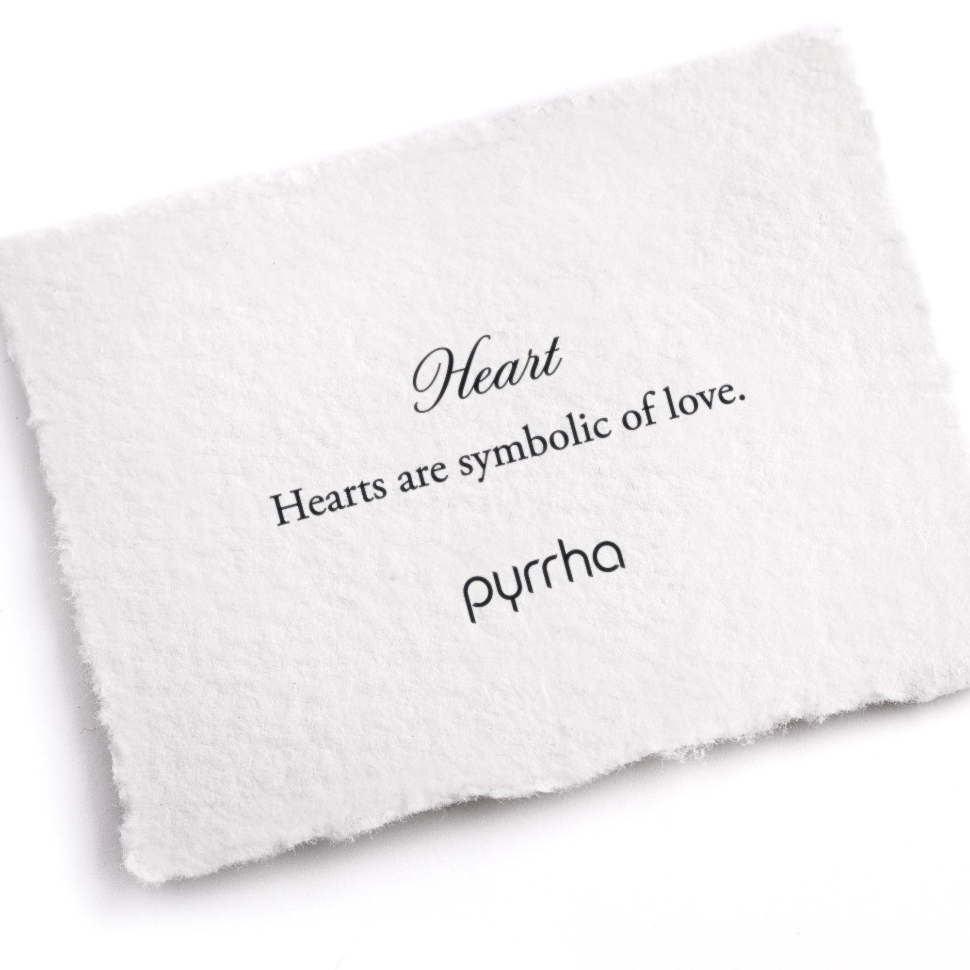 A hand-torn, letterpress printed card describing the meaning for Pyrrha's Heart Symbol Charm