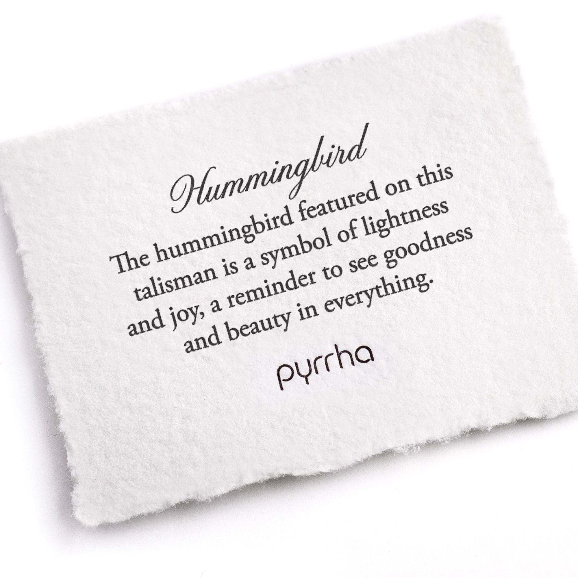 A hand-torn, letterpress printed card describing the meaning for Pyrrha's Hummingbird Talisman