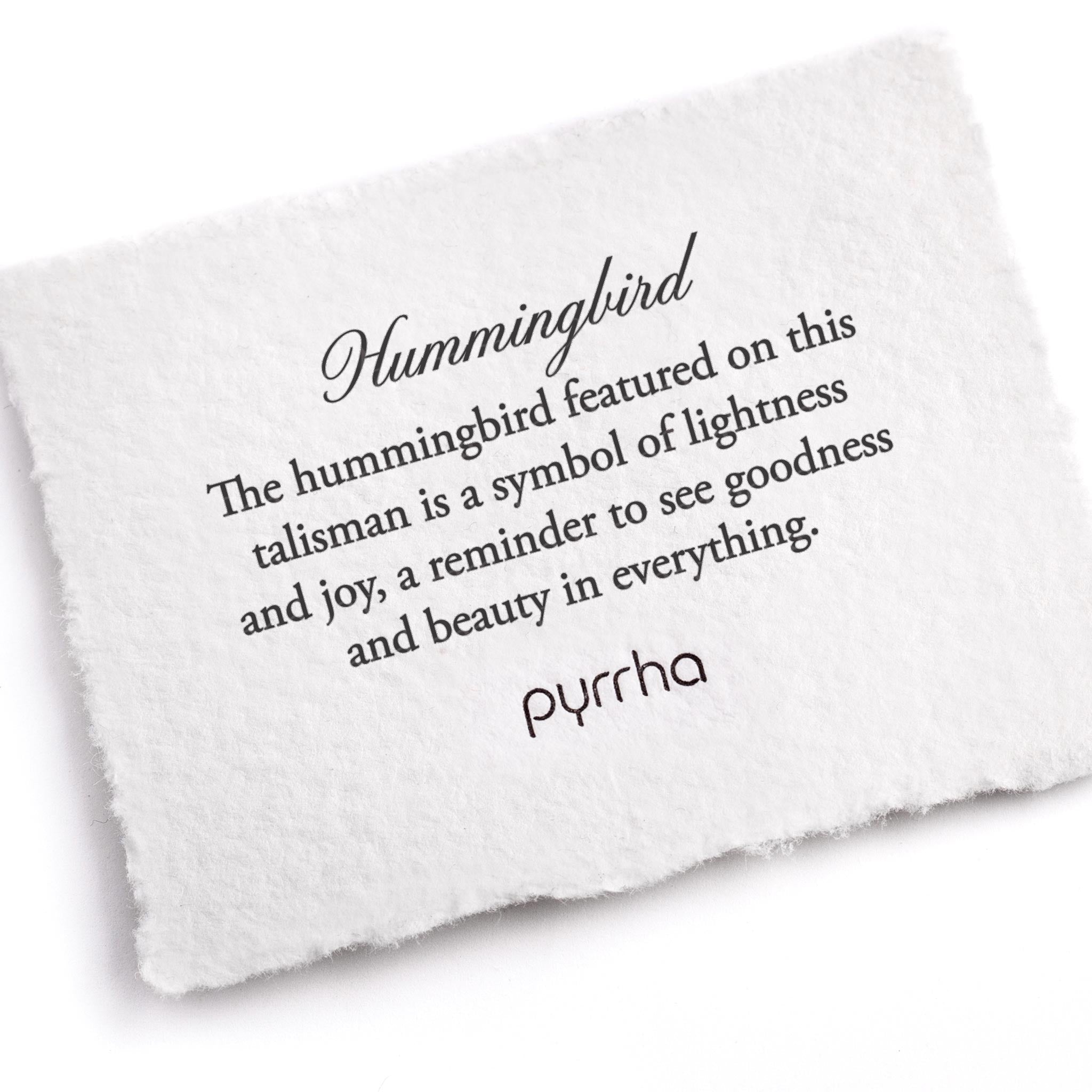 A hand-torn, letterpress printed card describing the meaning for Pyrrha's Hummingbird Talisman