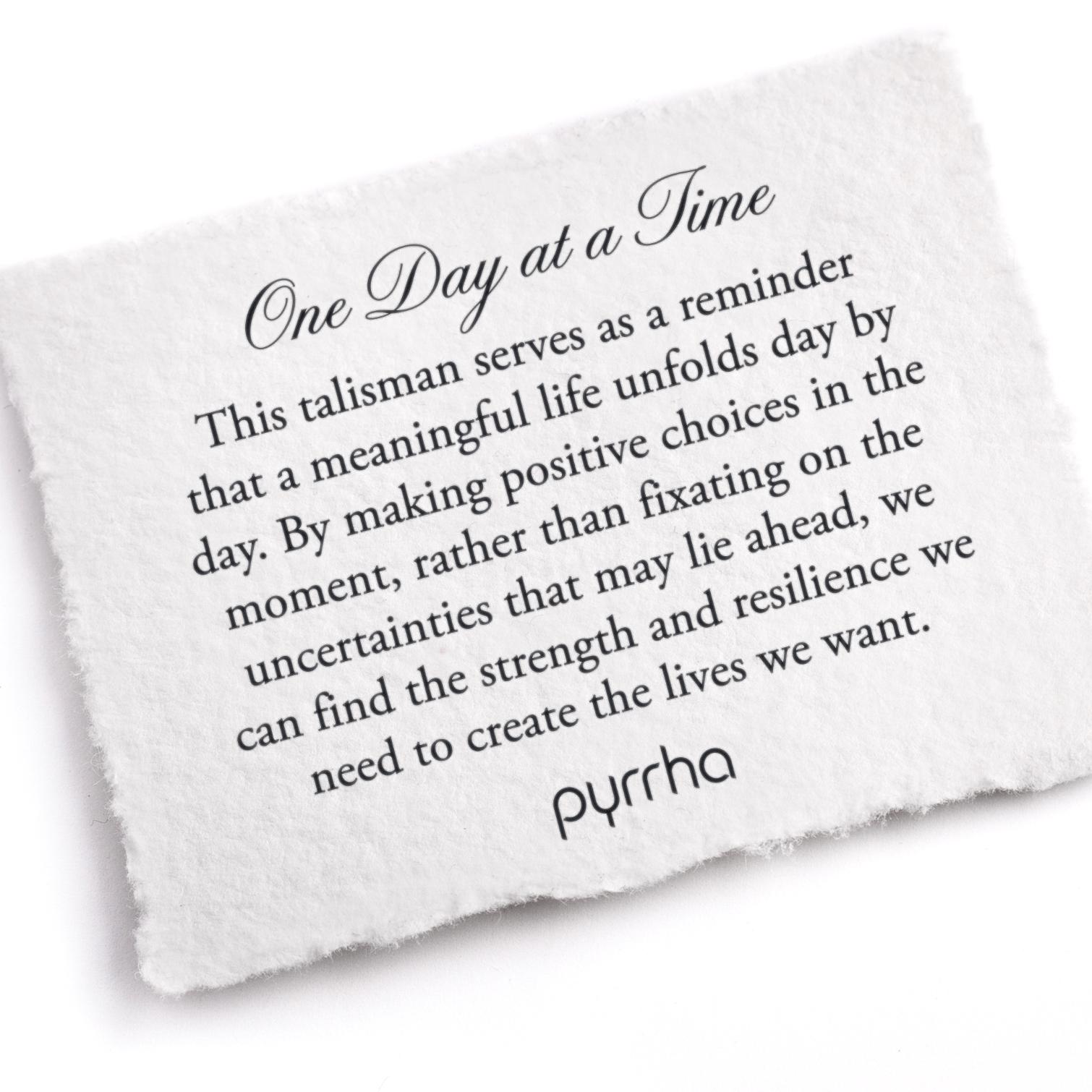A hand-torn, letterpress printed card describing the meaning for Pyrrha's One Day at a Time Talisman