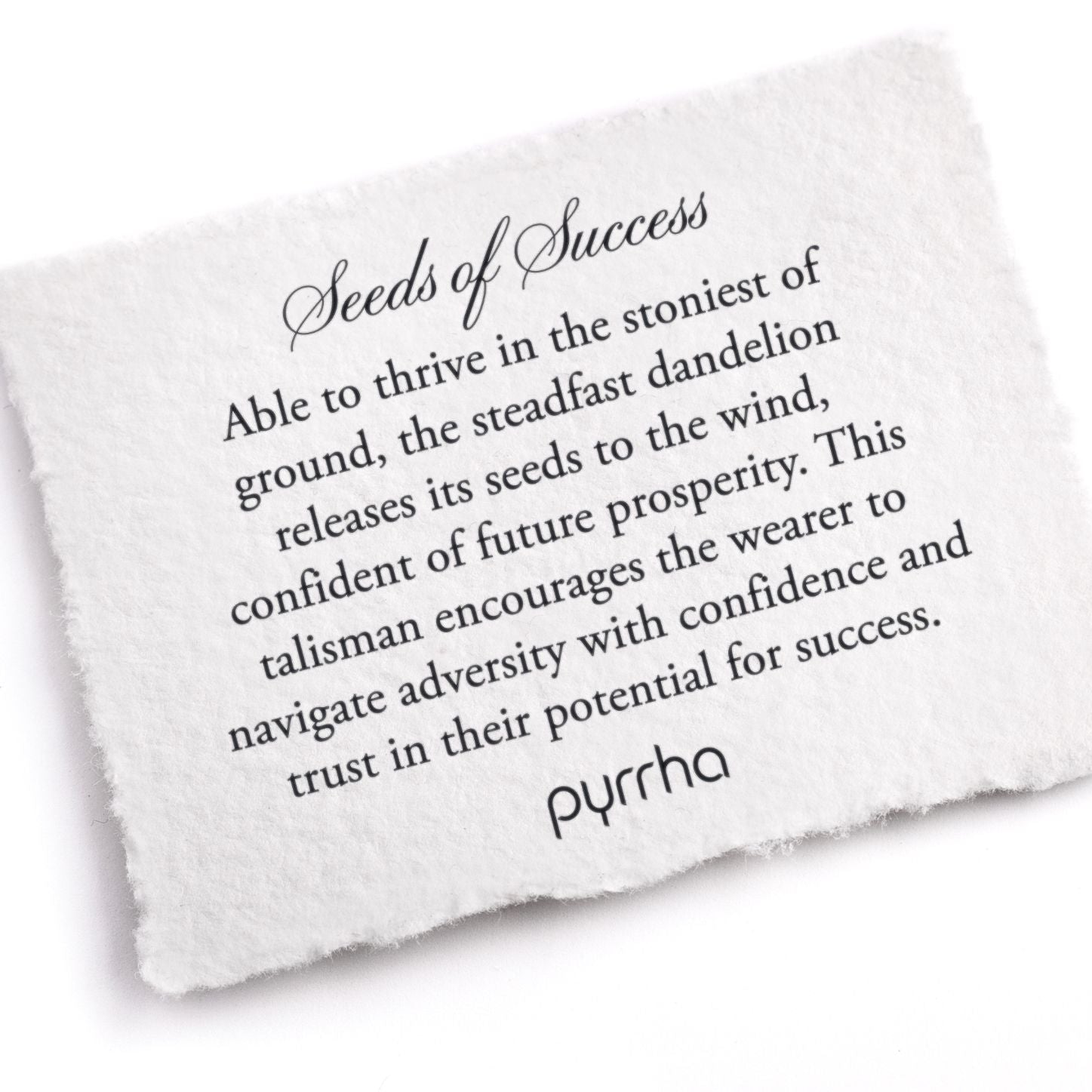 A hand-torn, letterpress printed card describing the meaning for Pyrrha's Seeds of Success Talisman