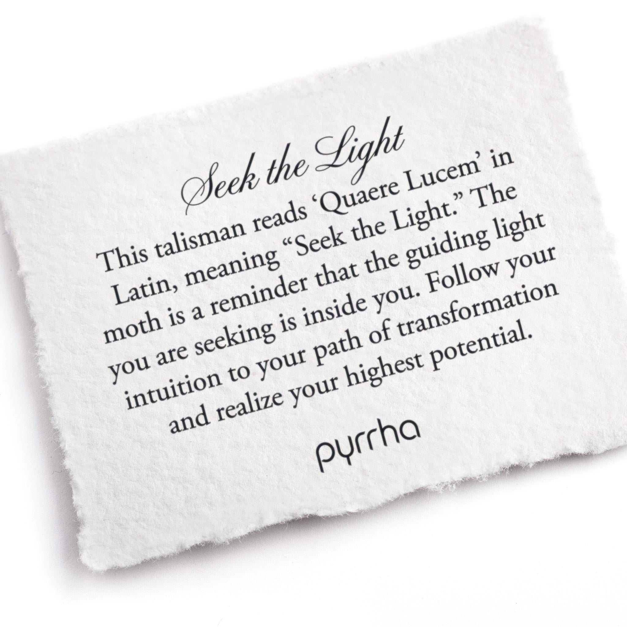 A hand-torn, letterpress printed card describing the meaning for Pyrrha's Seek the Light Talisman