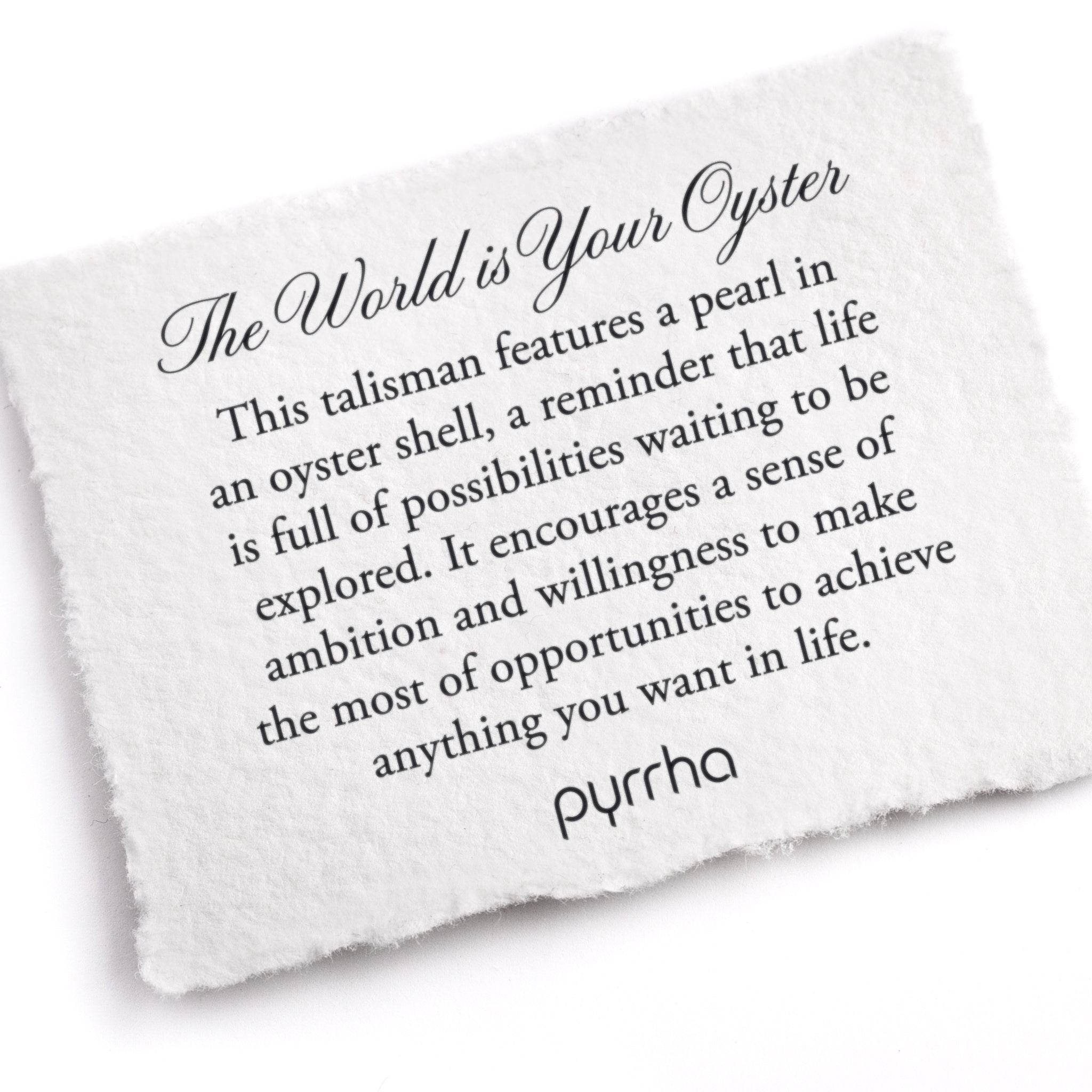 A hand-torn, letterpress printed card describing the meaning for Pyrrha's The World is Your Oyster Talisman