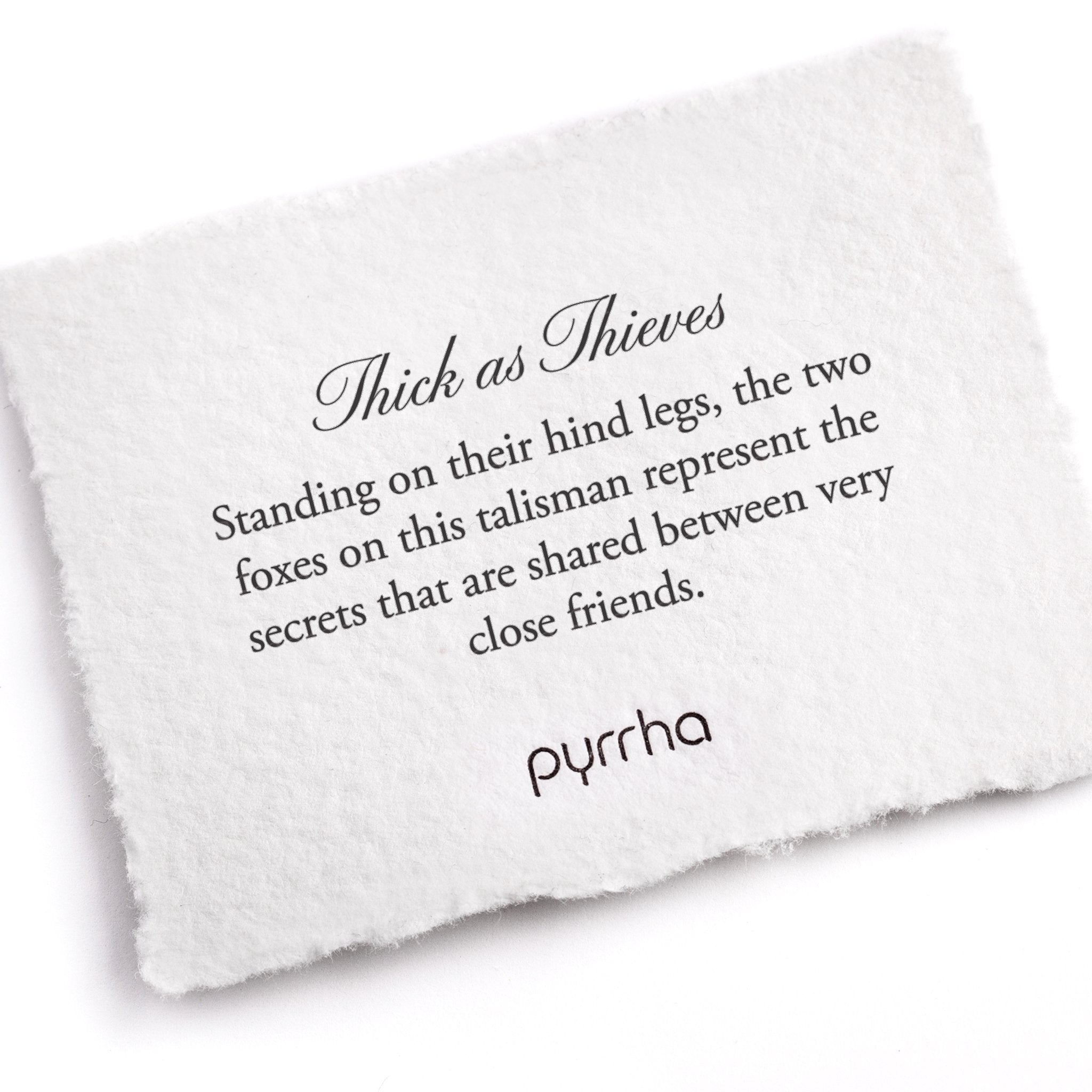 A hand-torn, letterpress printed card describing the meaning for Pyrrha's Thick as Thieves Talisman