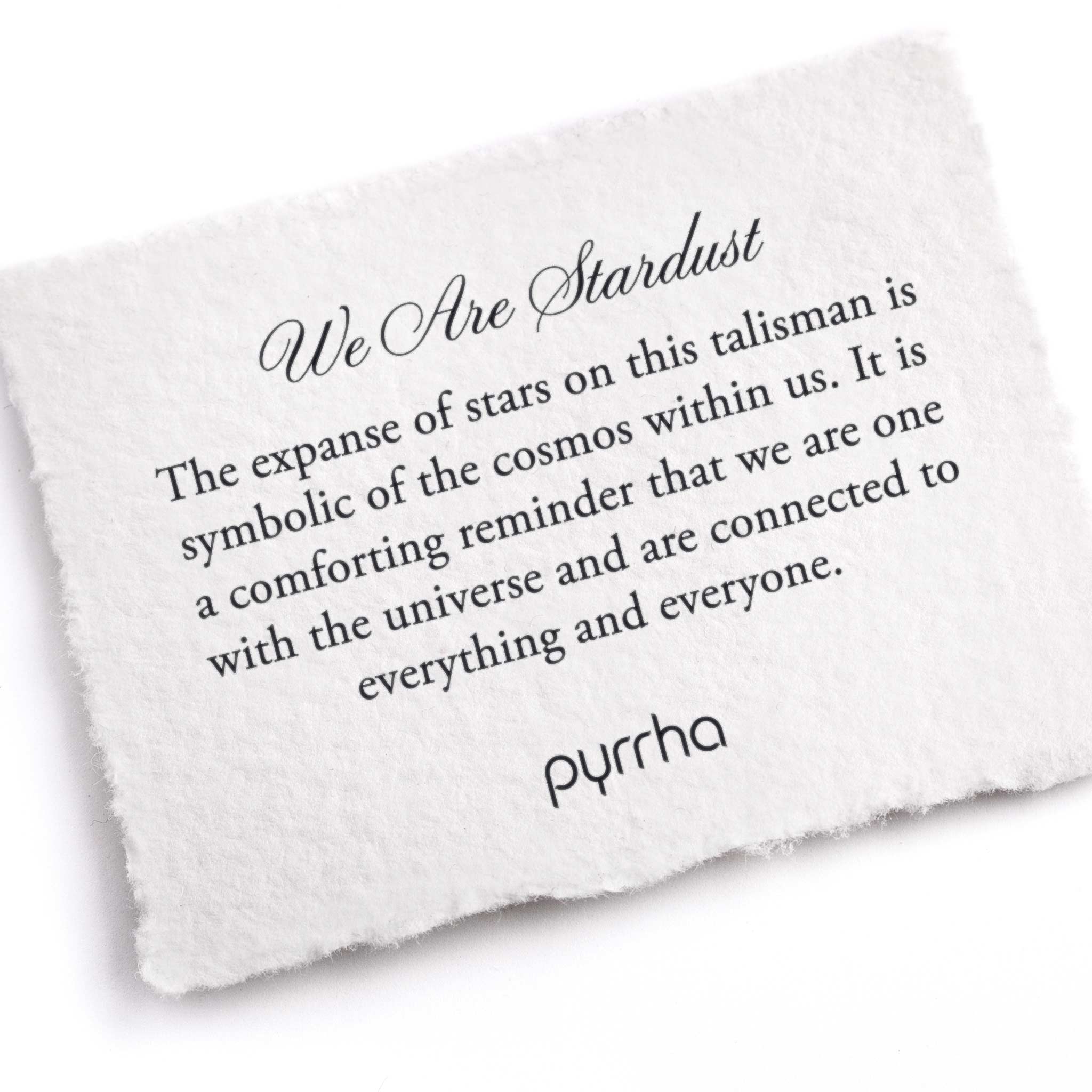 A hand-torn, letterpress printed card describing the meaning for Pyrrha's We Are Stardust Talisman