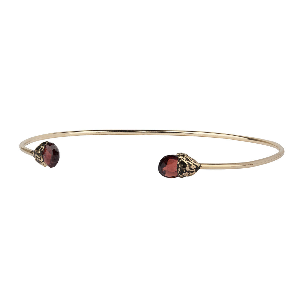 A 14k gold bangle made to hold charms capped with a semi precious stone representing clarity.