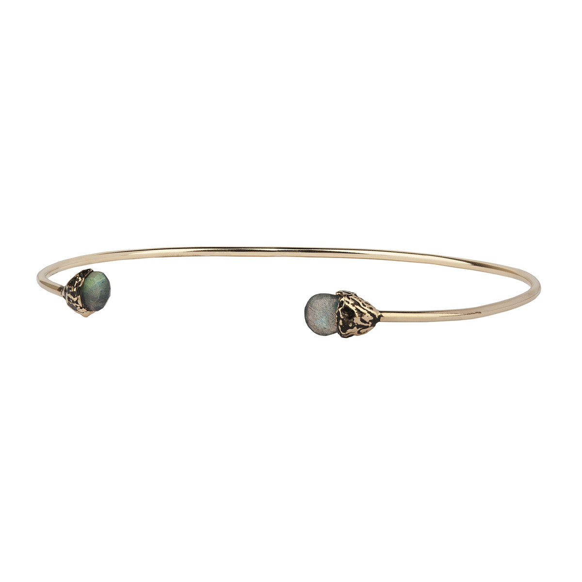 A 14k gold bangle made to hold charms capped with a semi precious stone representing Harmony.