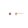 A set of 14k gold stud earrings set with a ruby.