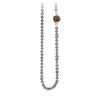A necklace of hand strung dove grey pearls with a 14k gold bezel set charcoal diamond.