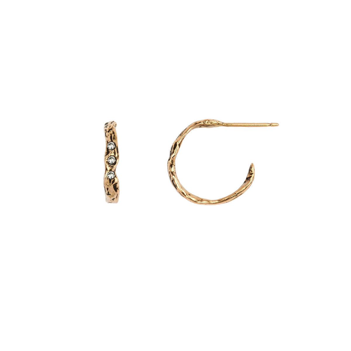 A set of extra small 14k gold hoop earrings with a textured design and three diamonds.