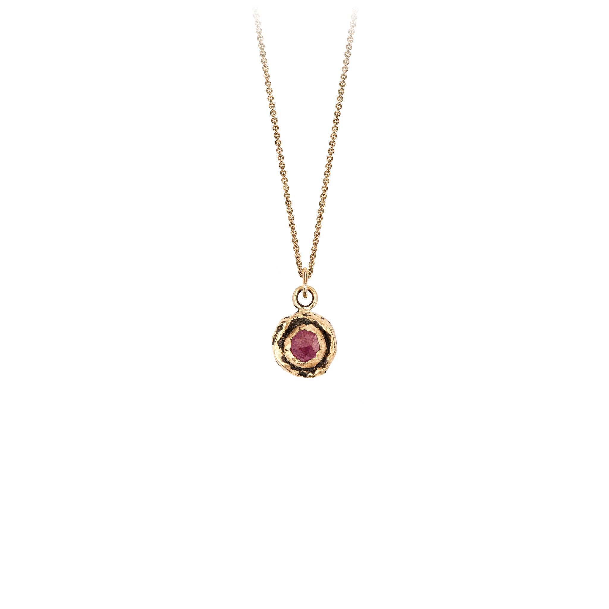 A 14k gold chain featuring a small 14k gold faceted ruby.