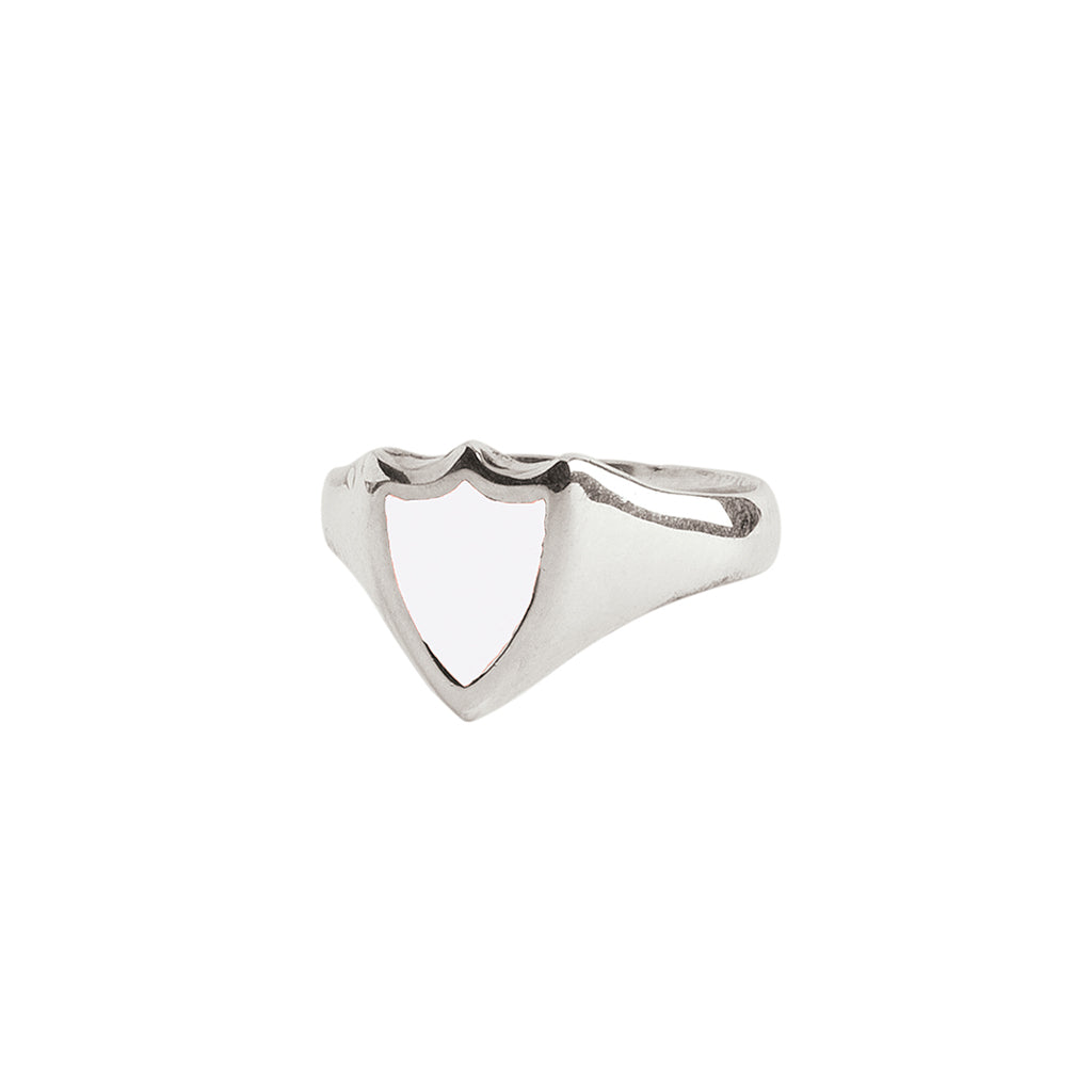A silver signet ring with our sterling silver and white Peace Shield talisman.