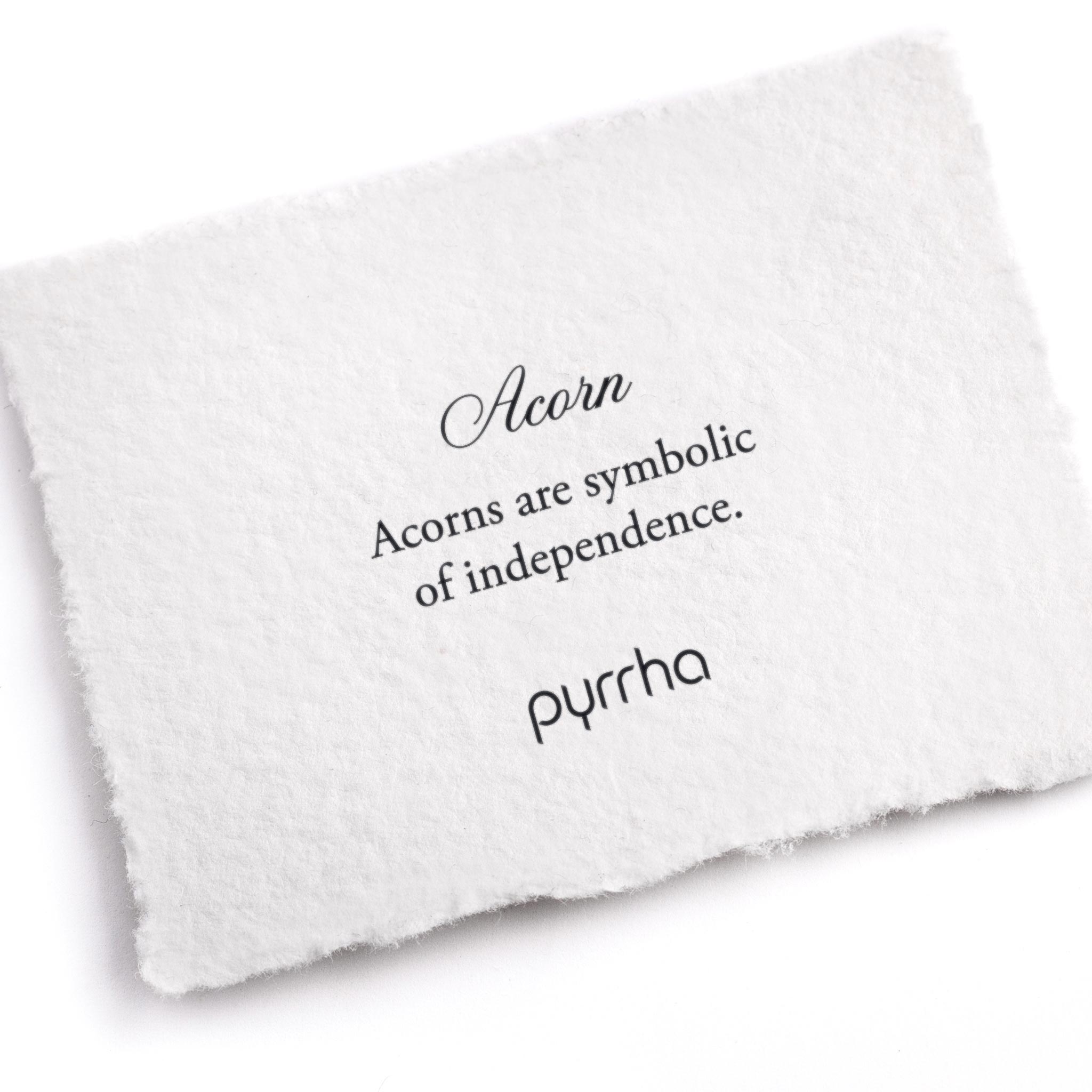 A hand-torn, letterpress printed card describing the meaning for Pyrrha's Acorn Symbol Charm