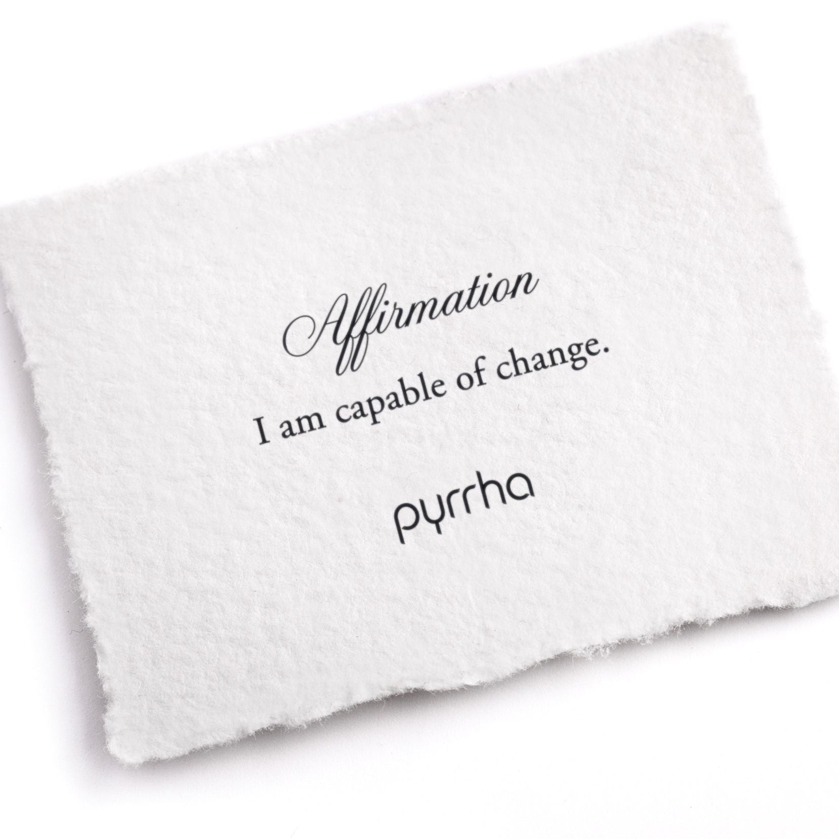 A hand-torn, letterpress printed card describing the meaning for Pyrrha's I am capable of change Affirmation Talisman