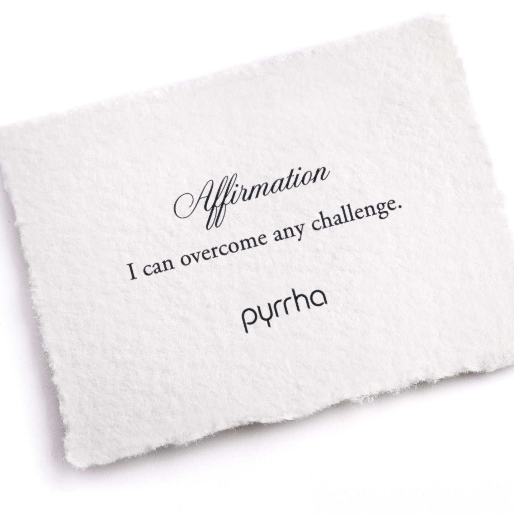 A hand-torn, letterpress printed card describing the meaning for Pyrrha's I can overcome any challenge Affirmation Talisman