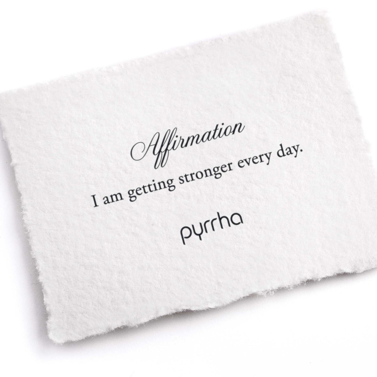A hand-torn, letterpress printed card describing the meaning for Pyrrha's I Am Getting Stronger Every Day Affirmation Talisman Necklace
