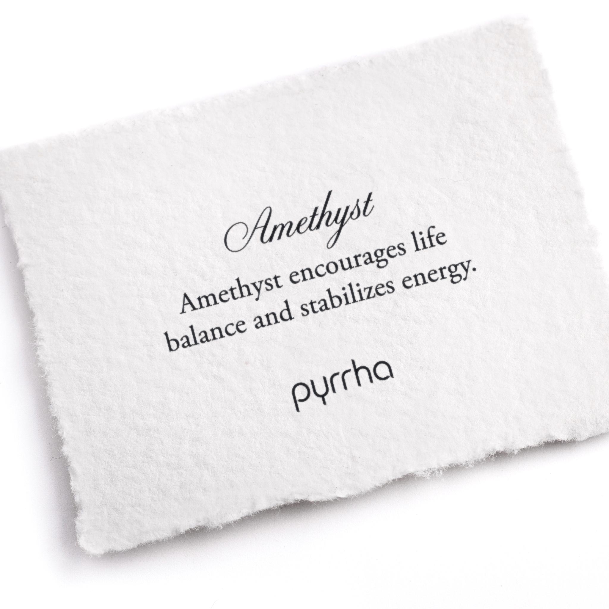 A hand-torn, letterpress printed card describing the meaning for Pyrrha's Amethyst stone