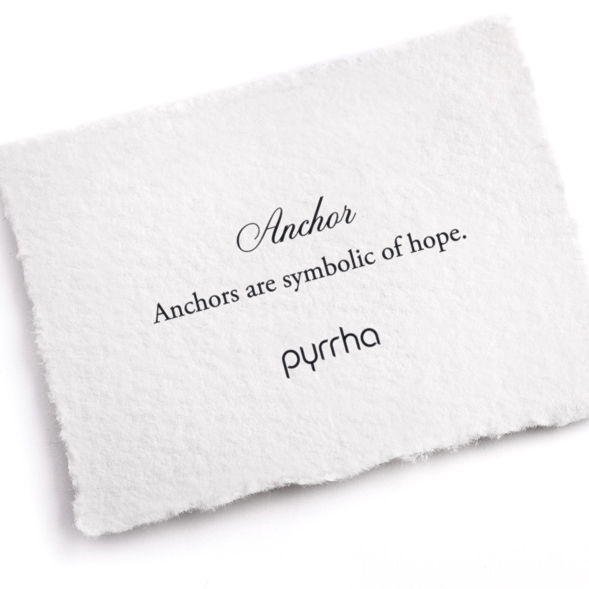 A hand-torn, letterpress printed card describing the meaning for Pyrrha's Anchor Symbol Charm