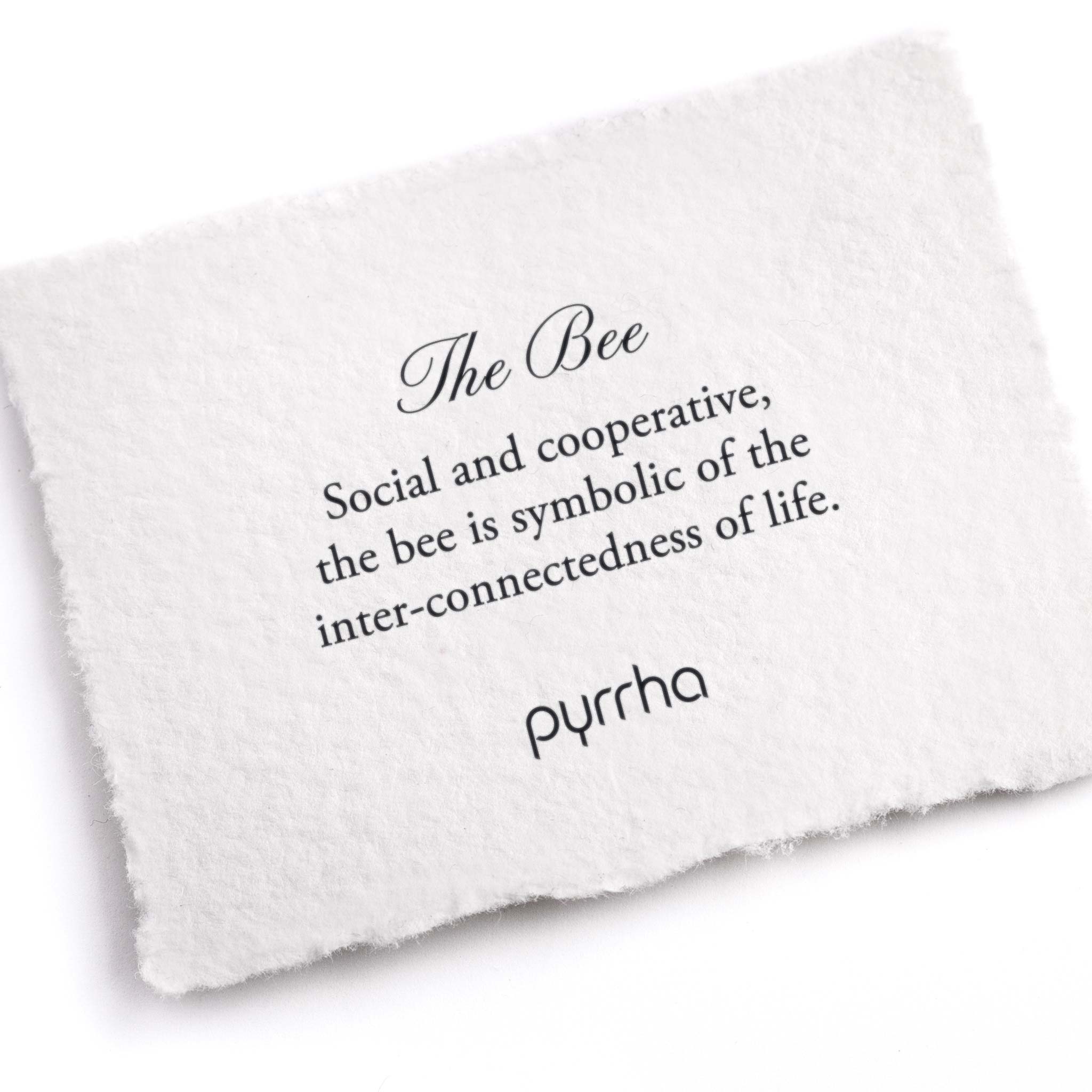 A hand-torn, letterpress printed card describing the meaning for Pyrrha's Bee Pin