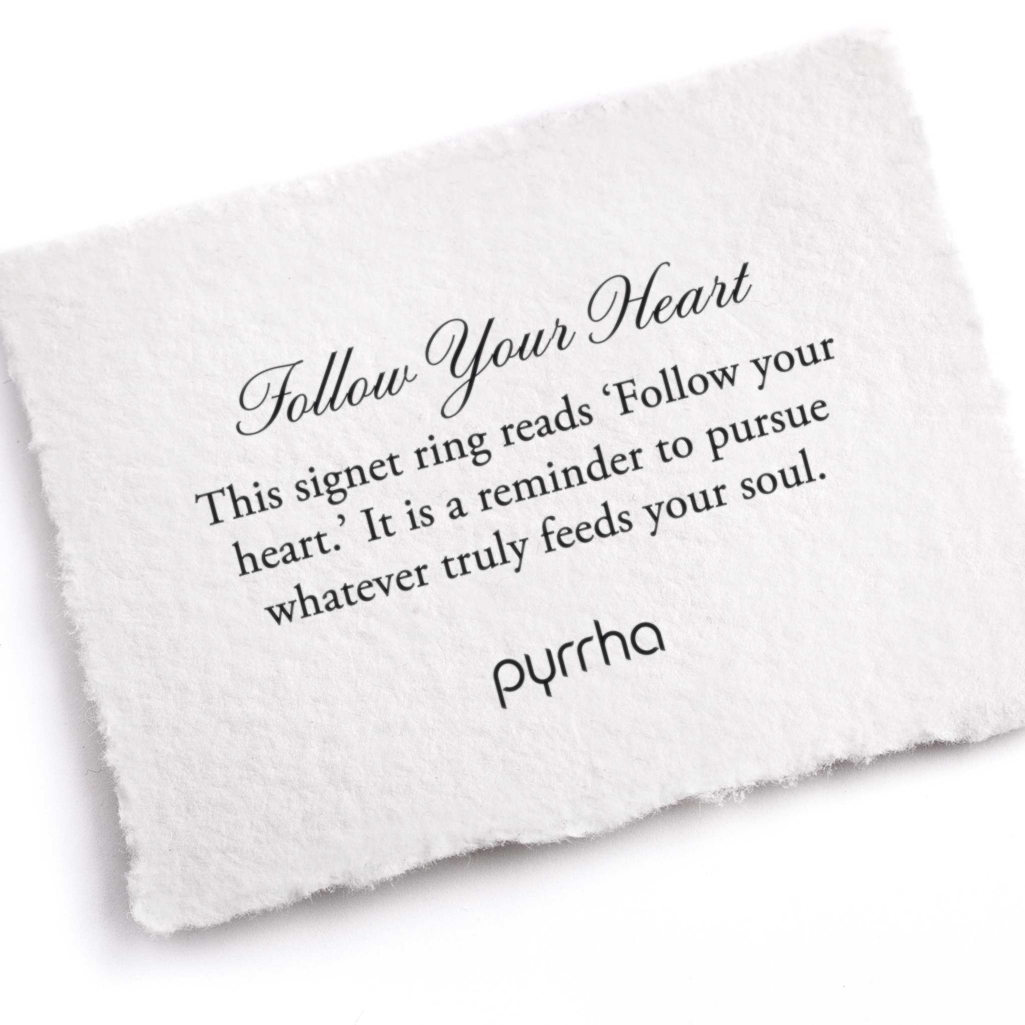 A hand-torn, letterpress printed card describing the meaning for Pyrrha's Follow Your Heart Signet Ring