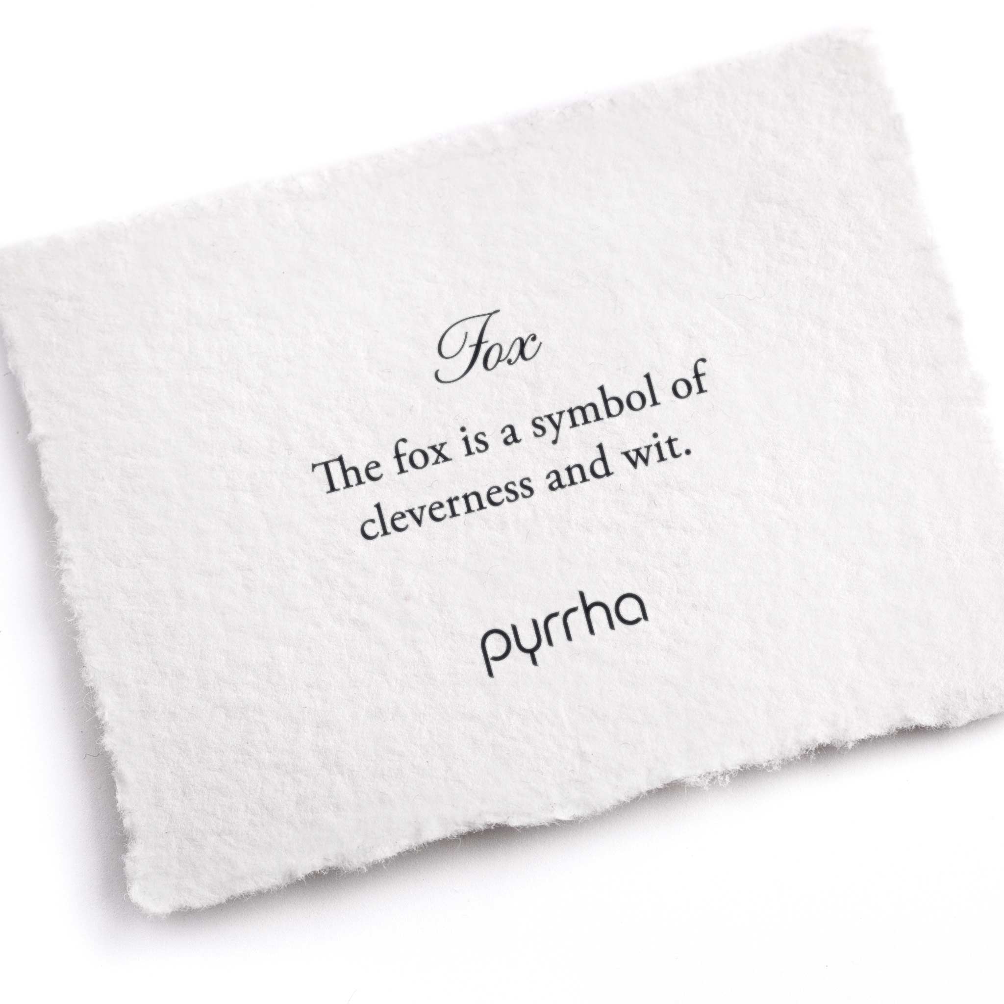 A hand-torn, letterpress printed card describing the meaning for Pyrrha's Fox Symbol Charm