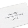 A handtorn cotton card describing the meaning for our friendship open bangle