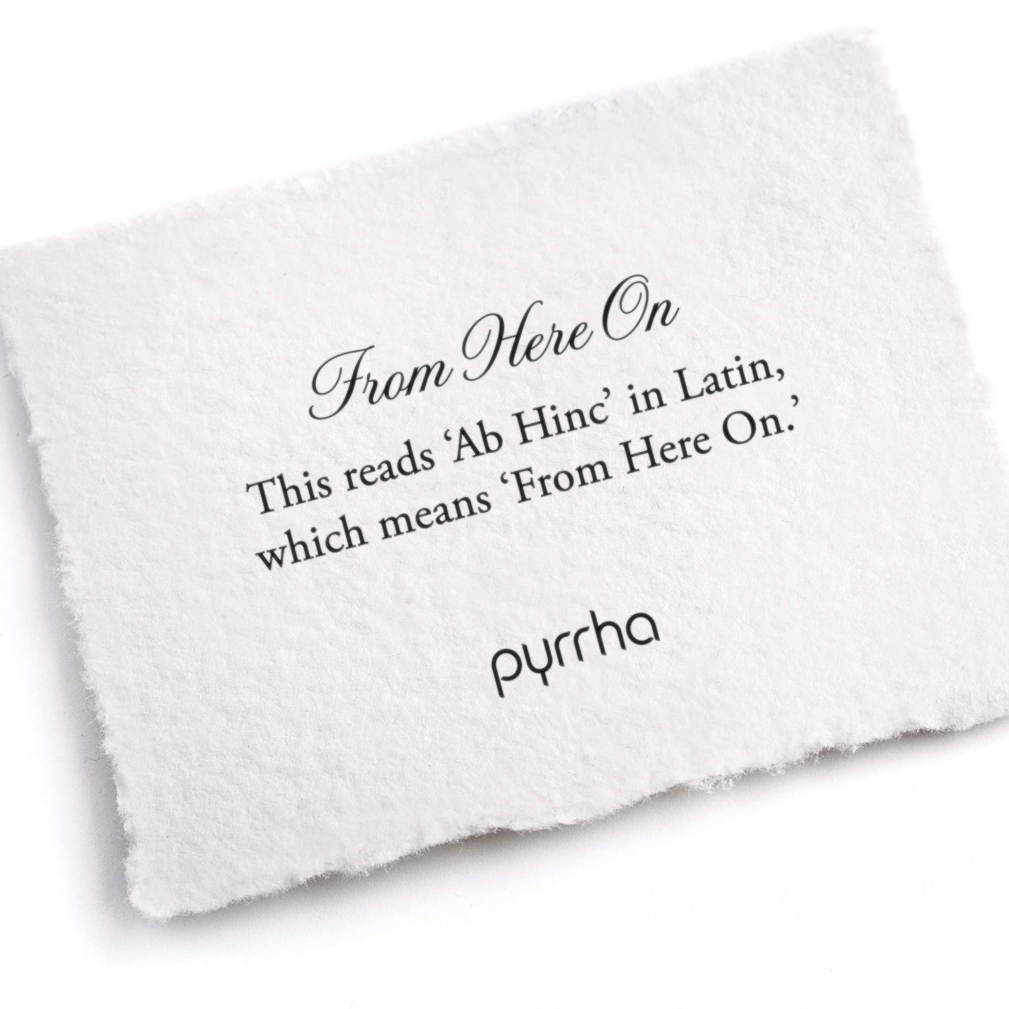 A hand-torn, letterpress printed card describing the meaning for Pyrrha's From Here On Latin Textured Band Ring