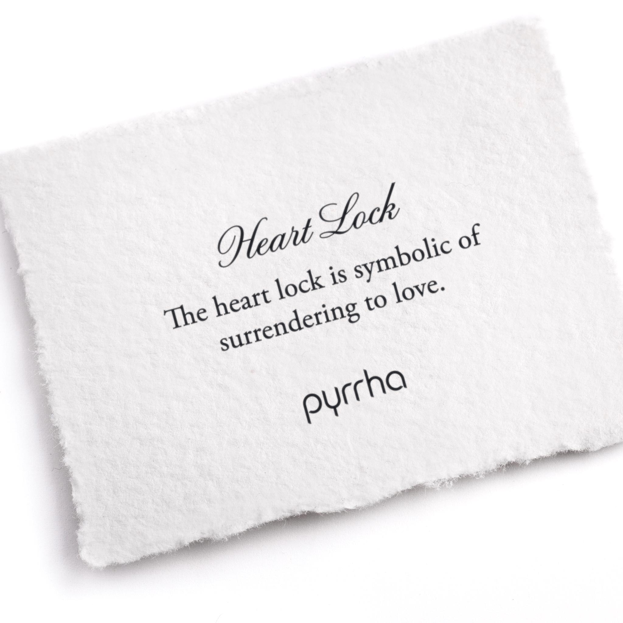 A hand-torn, letterpress printed card describing the meaning for Pyrrha's Heart Lock Symbol Charm