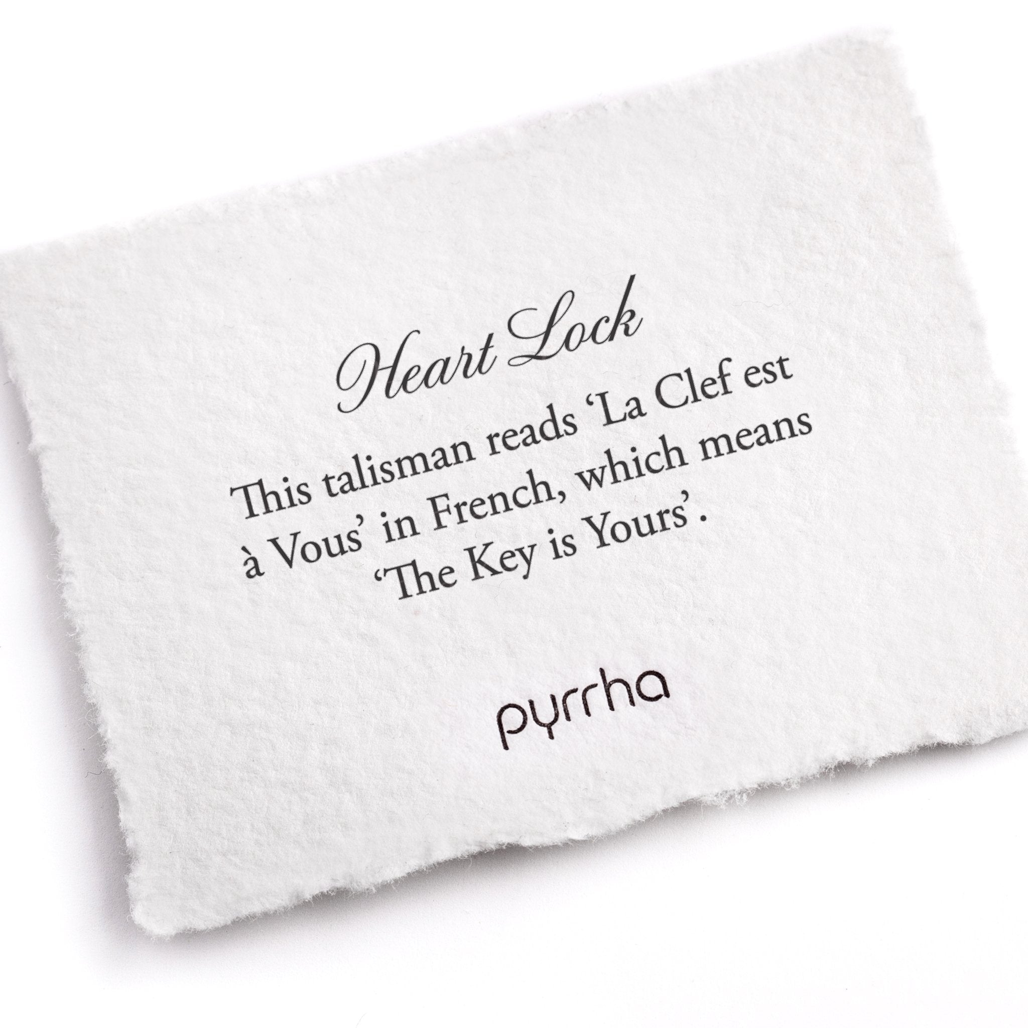 A hand-torn, letterpress printed card describing the meaning for Pyrrha's Heart Lock Talisman