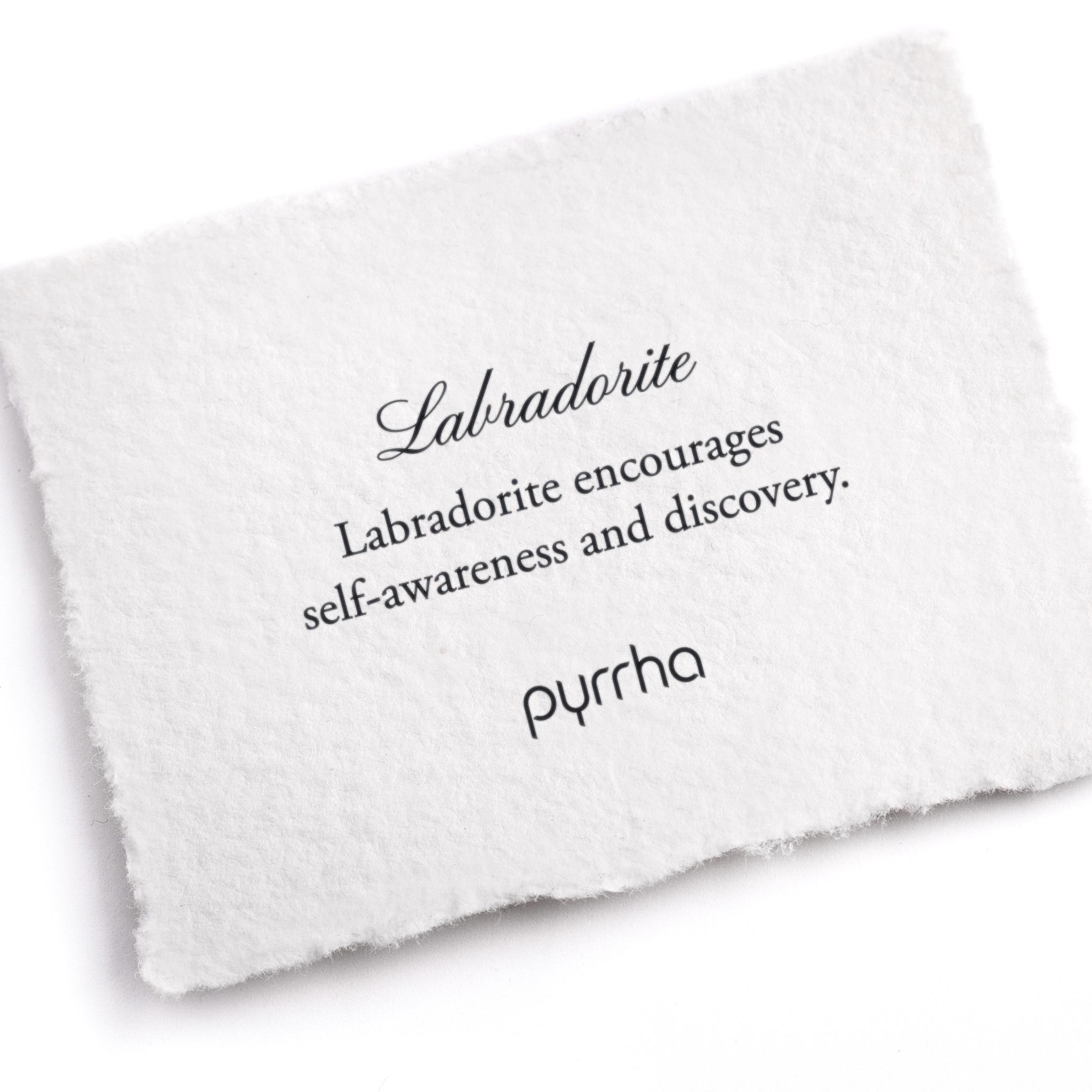 A hand-torn, letterpress printed card describing the meaning for Pyrrha's Labradorite stone