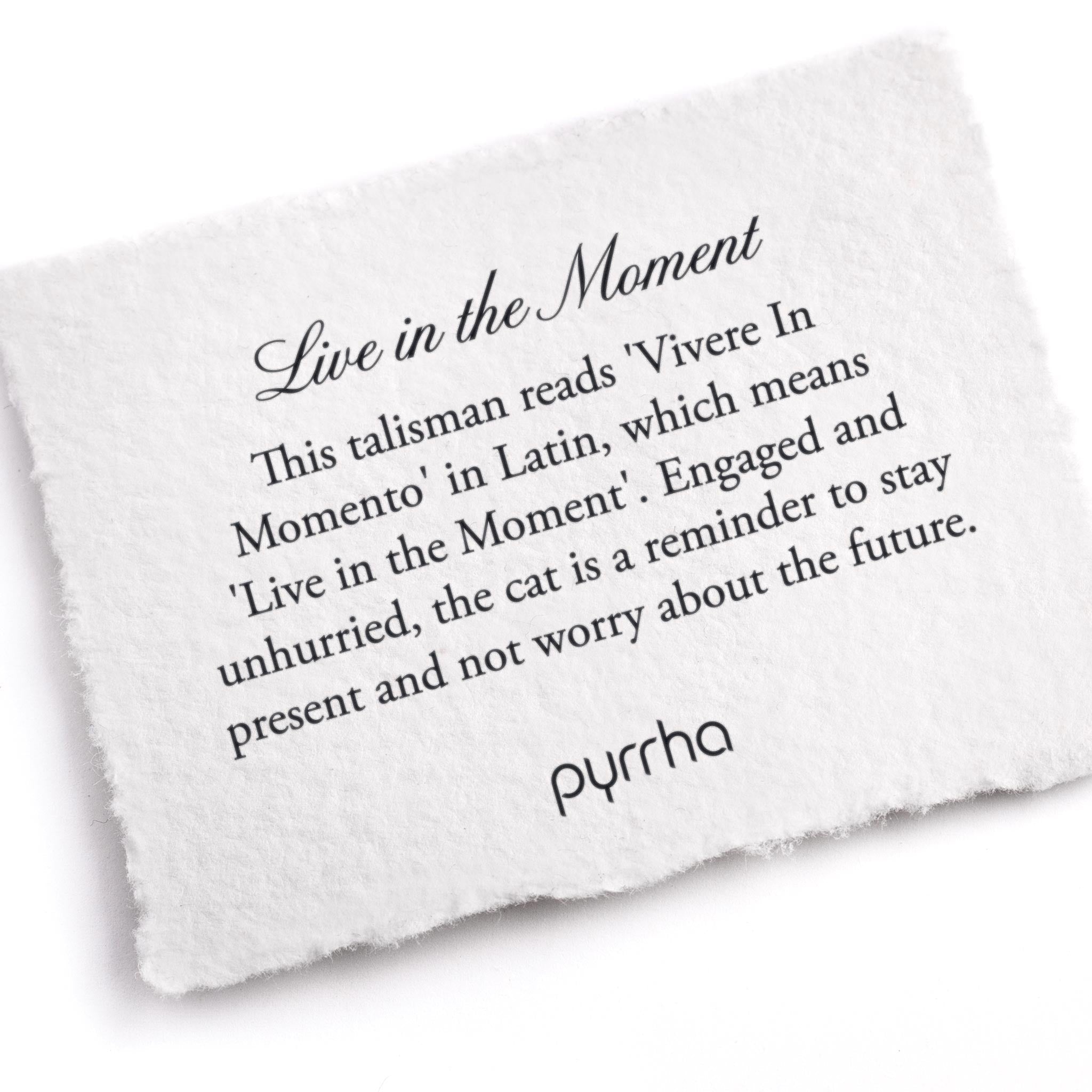 A hand-torn, letterpress printed card describing the meaning for Pyrrha's Live in the Moment Talisman