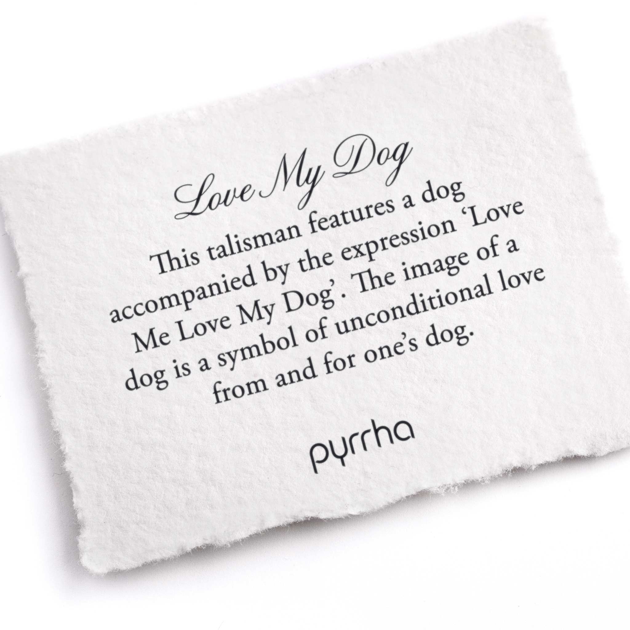 A hand-torn, letterpress printed card describing the meaning for Pyrrha's Love My Dog Talisman