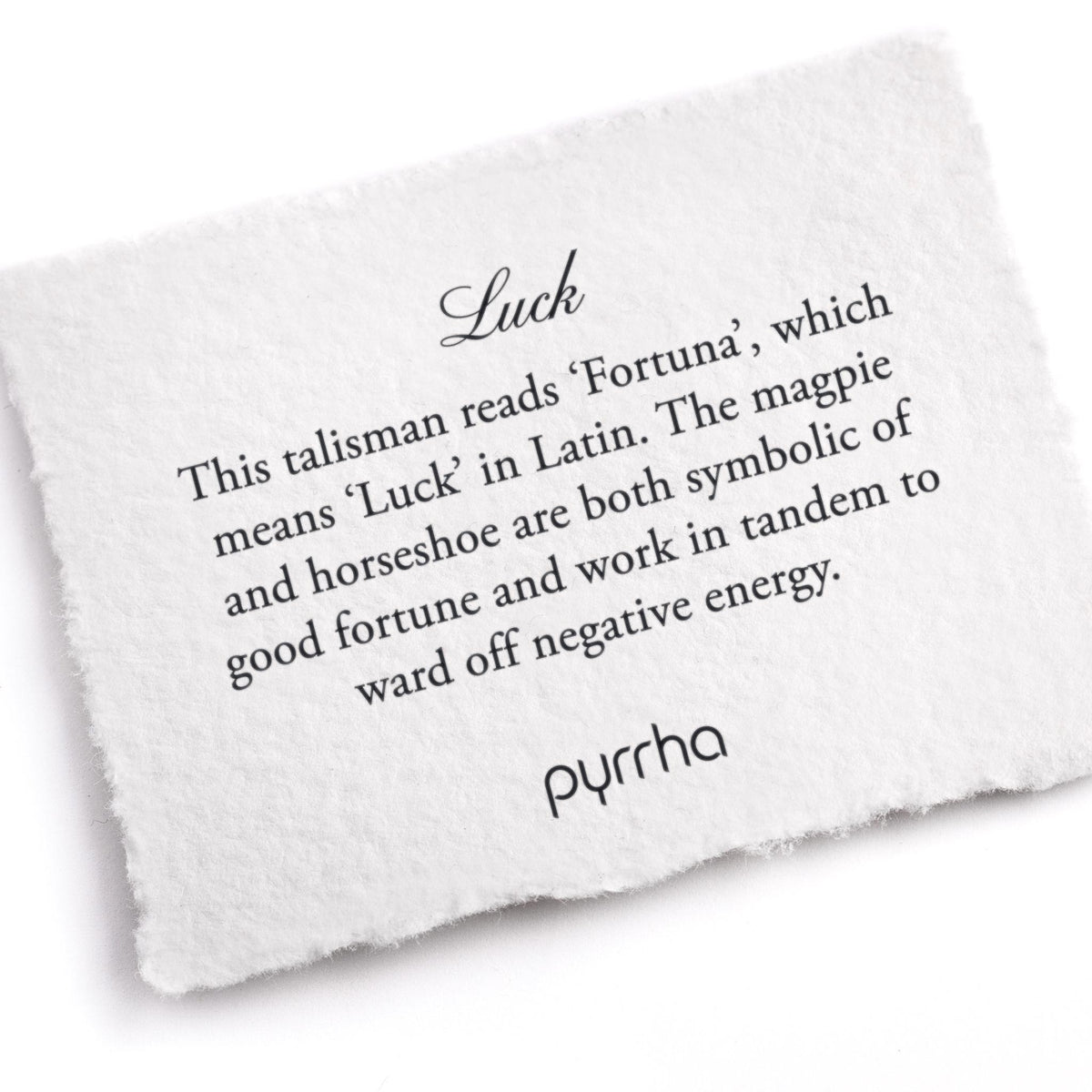 A hand-torn, letterpress printed card describing the meaning for Pyrrha's Luck Talisman