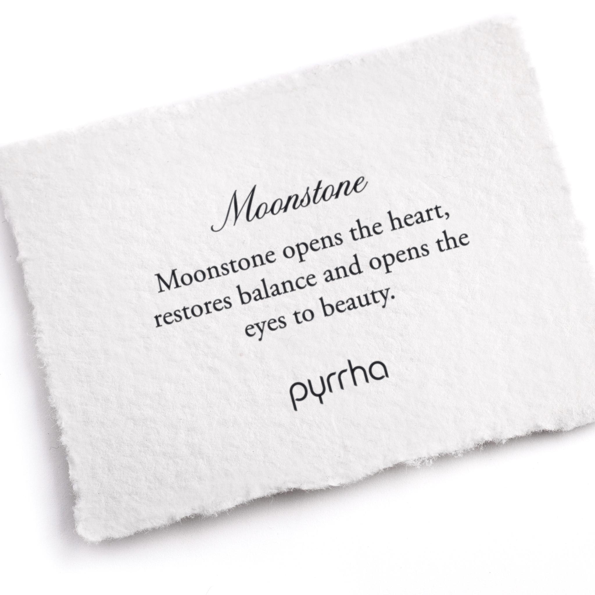 A hand-torn, letterpress printed card describing the meaning for Pyrrha's Moonstone stone