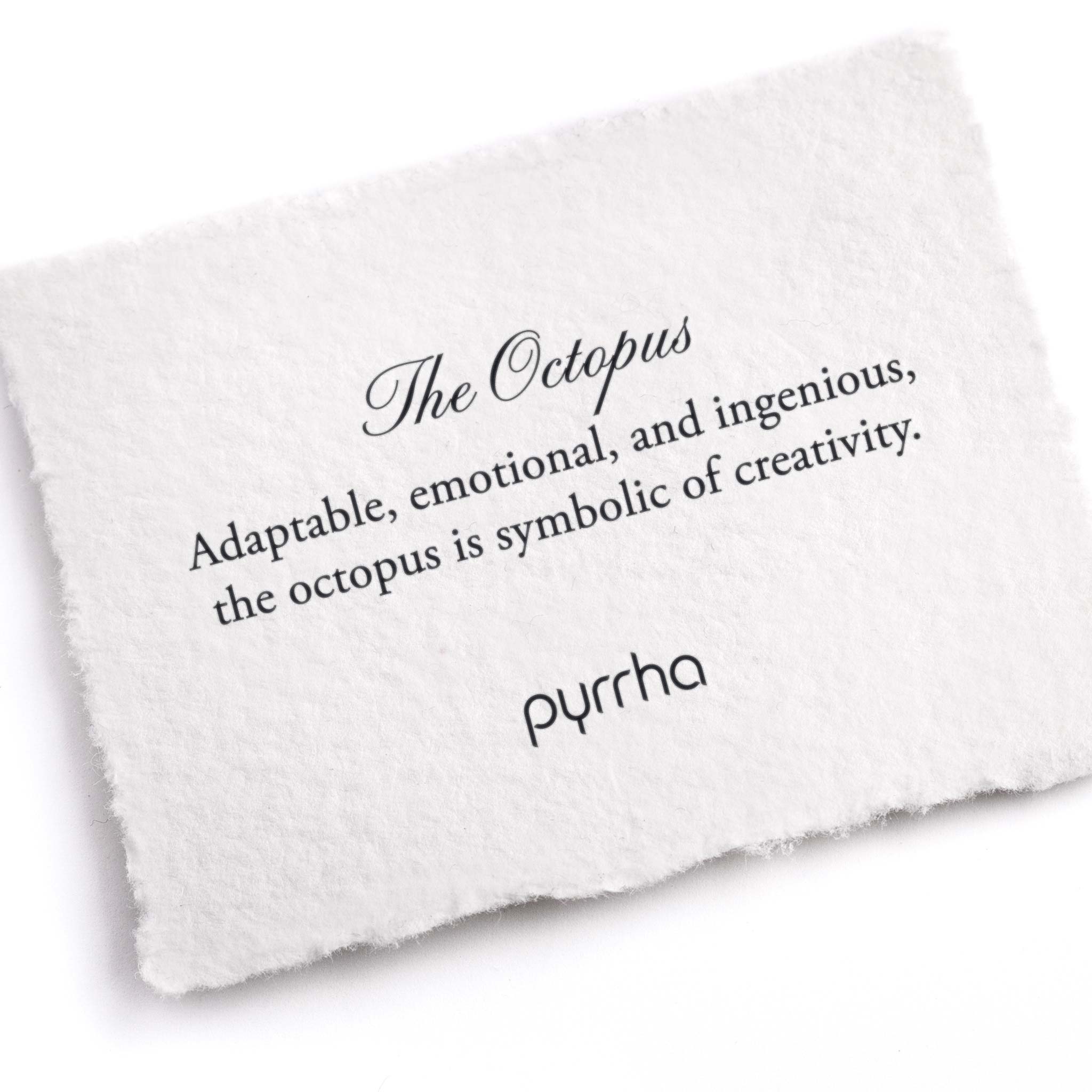 A hand-torn, letterpress printed card describing the meaning for Pyrrha's Octopus Pin