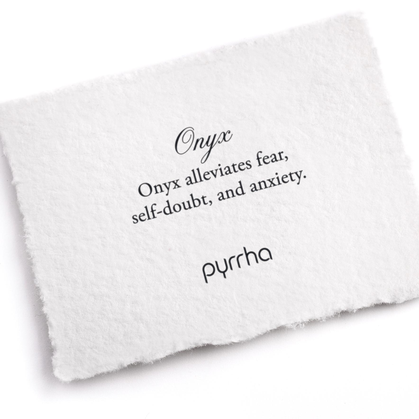 A hand-torn, letterpress printed card describing the meaning for Pyrrha's Onyx stone