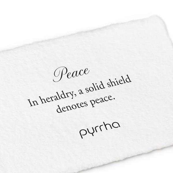 A hand-torn, letterpress printed card describing the meaning for Pyrrha's Peace Shield Charm