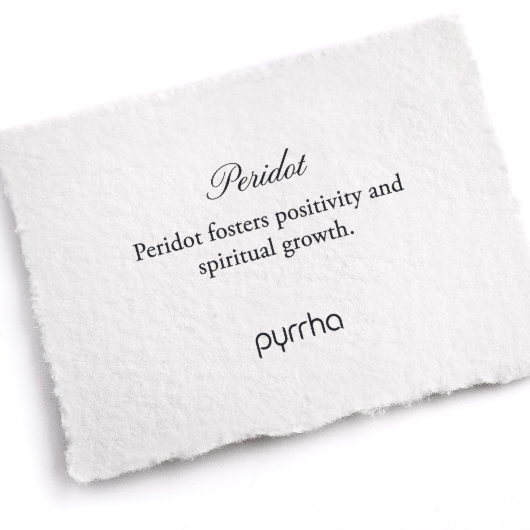 A hand-torn, letterpress printed card describing the meaning for Pyrrha's Peridot stone