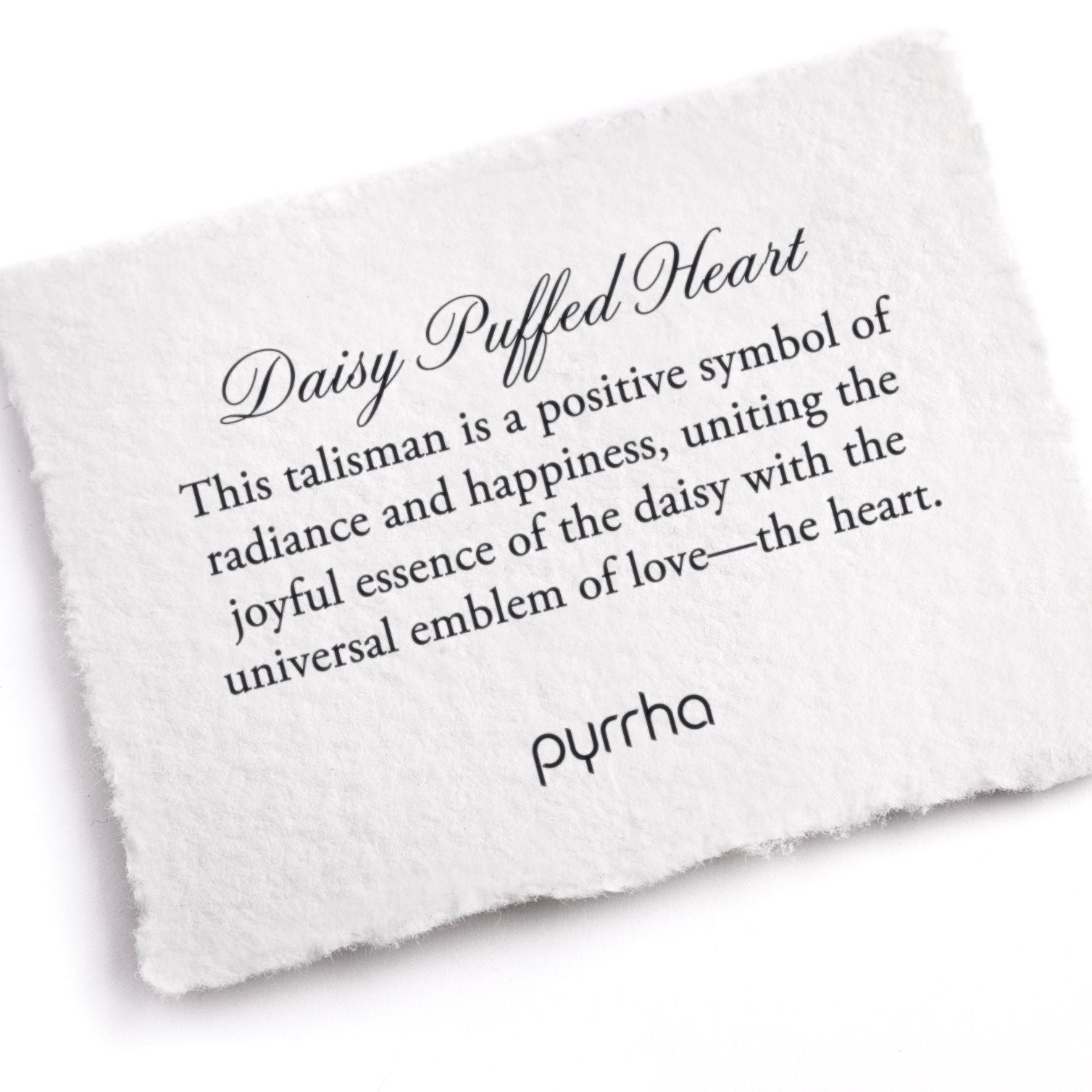 A hand-torn, letterpress printed card describing the meaning for Pyrrha's Daisy Puffed Heart Talisman