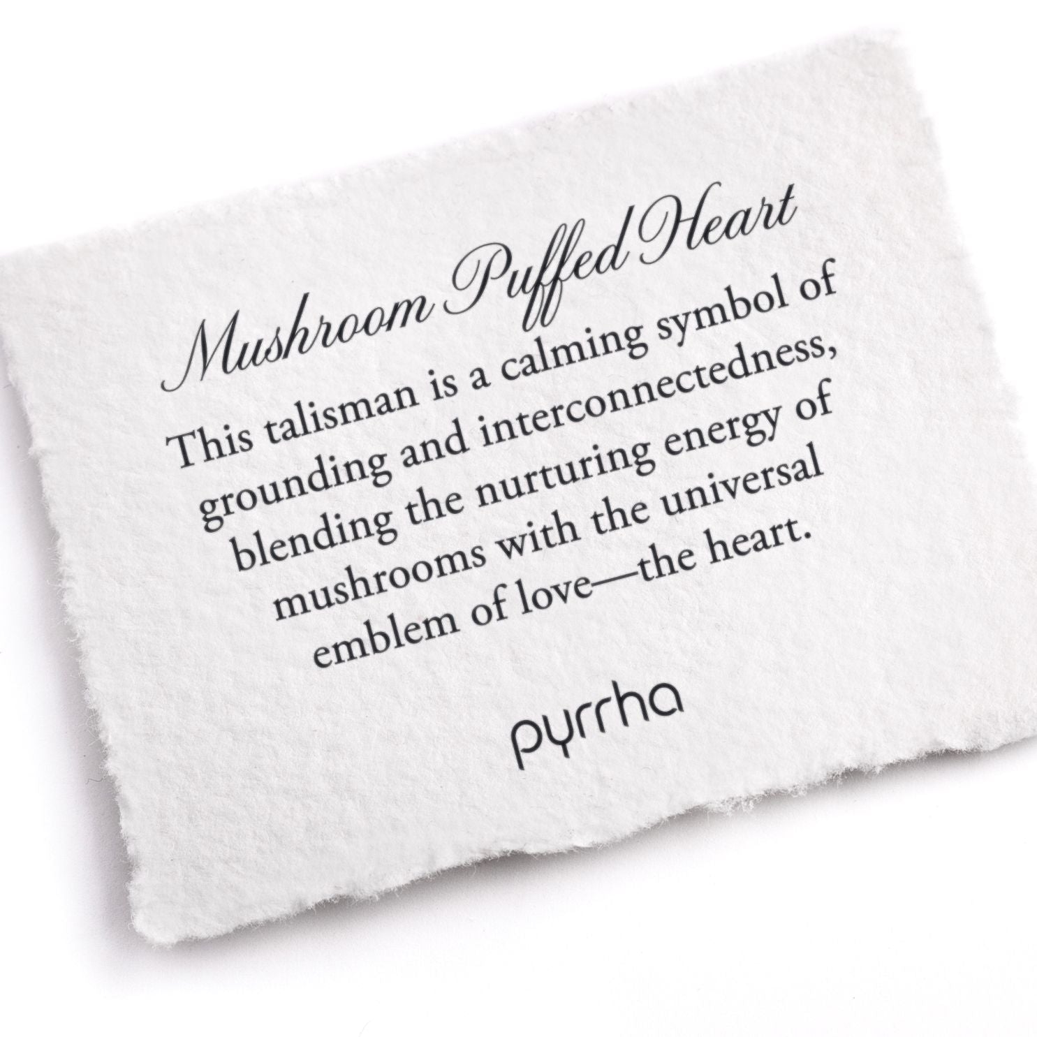 A hand-torn, letterpress printed card describing the meaning for Pyrrha's Mushroom Puffed Heart Talisman