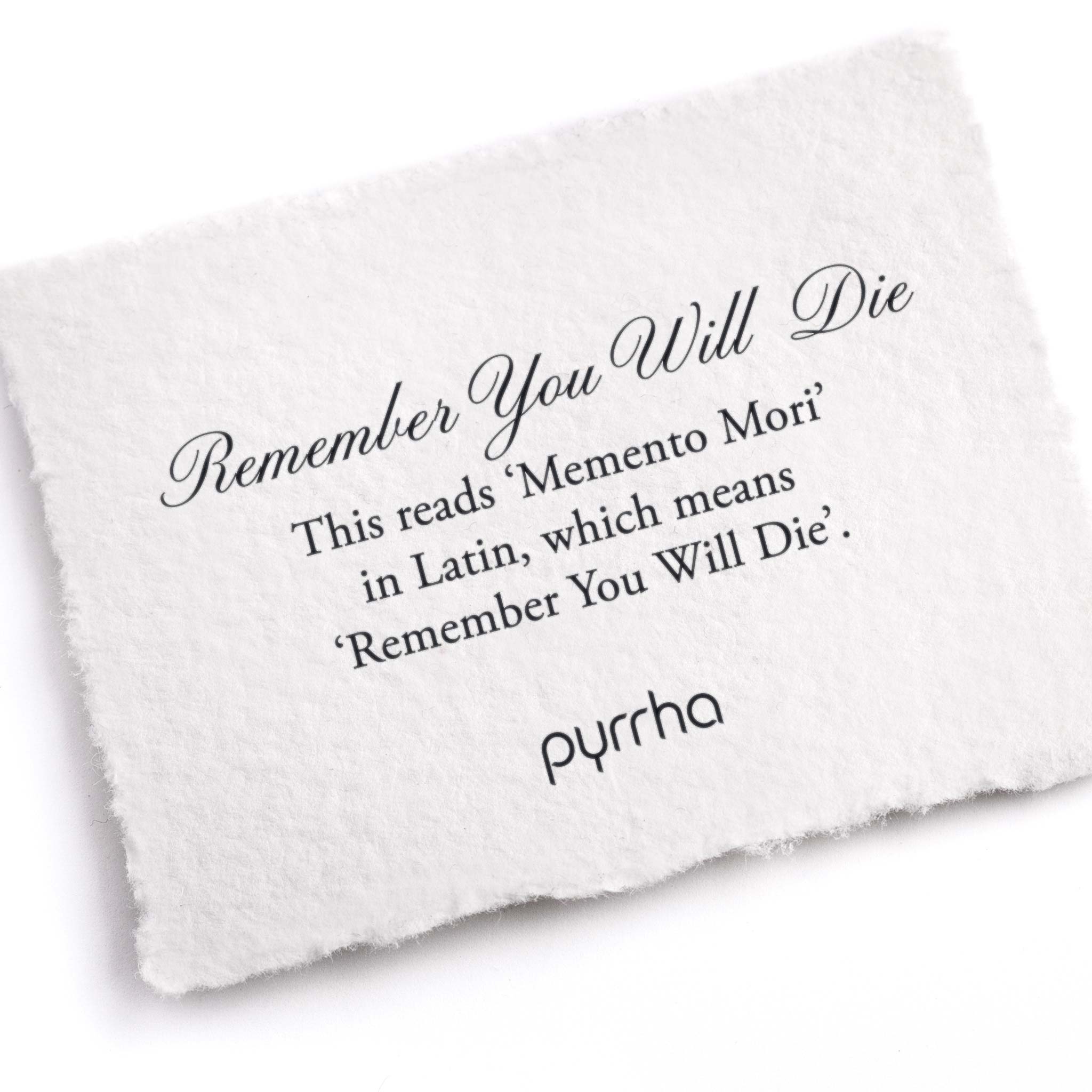 A hand-torn, letterpress printed card describing the meaning for Pyrrha's Remember You Will Die Latin Motto Band Ring
