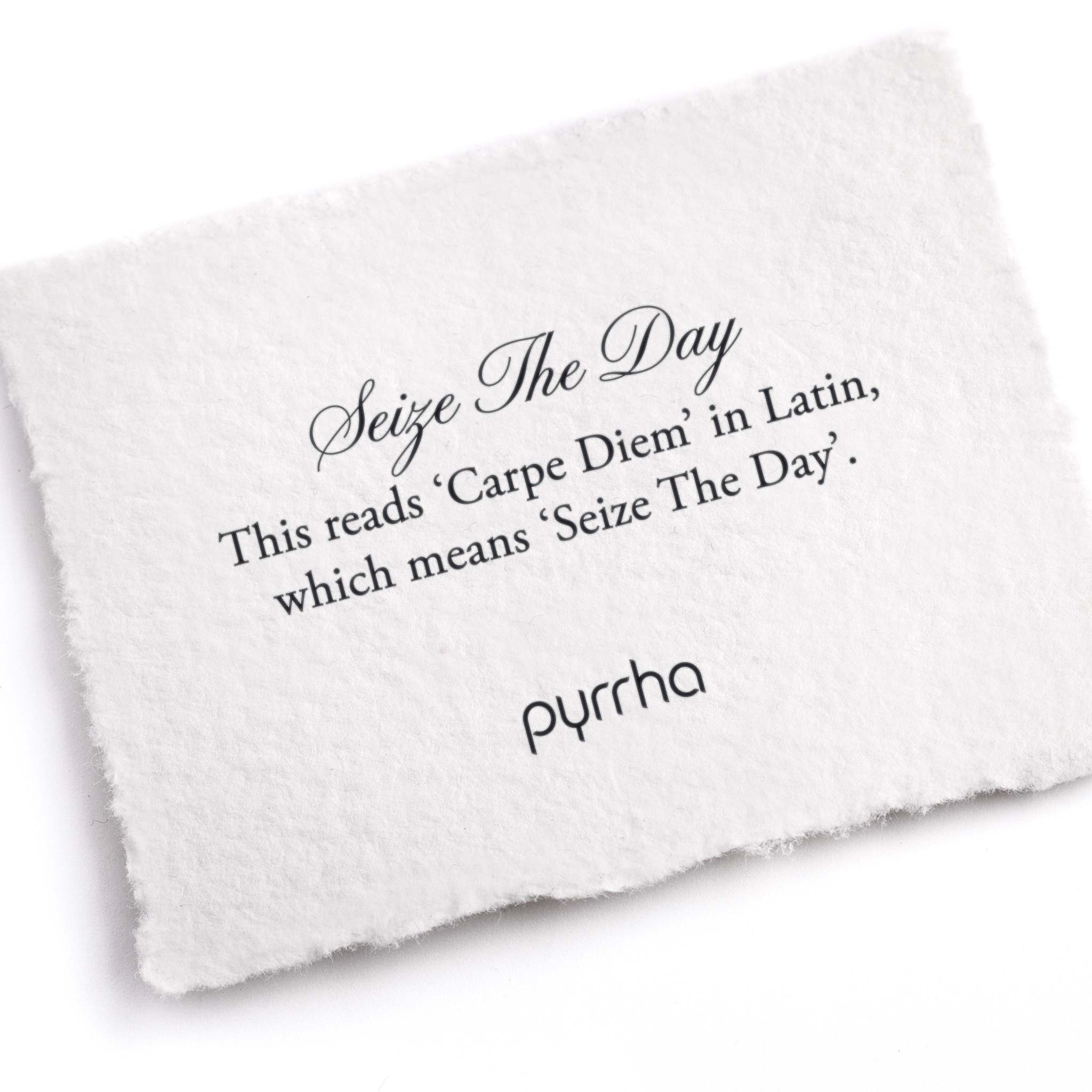 A hand-torn, letterpress printed card describing the meaning for Pyrrha's Seize The Day Ring