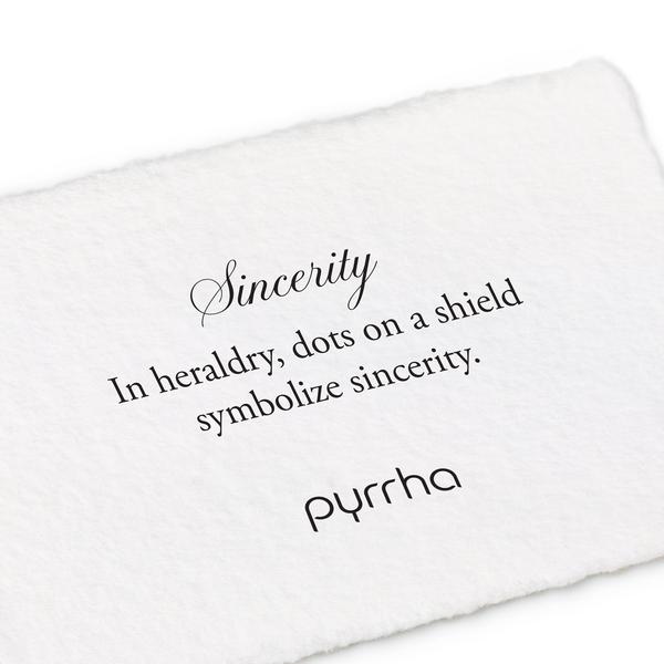 A hand-torn, letterpress printed card describing the meaning for Pyrrha's Sincerity Shield Charm