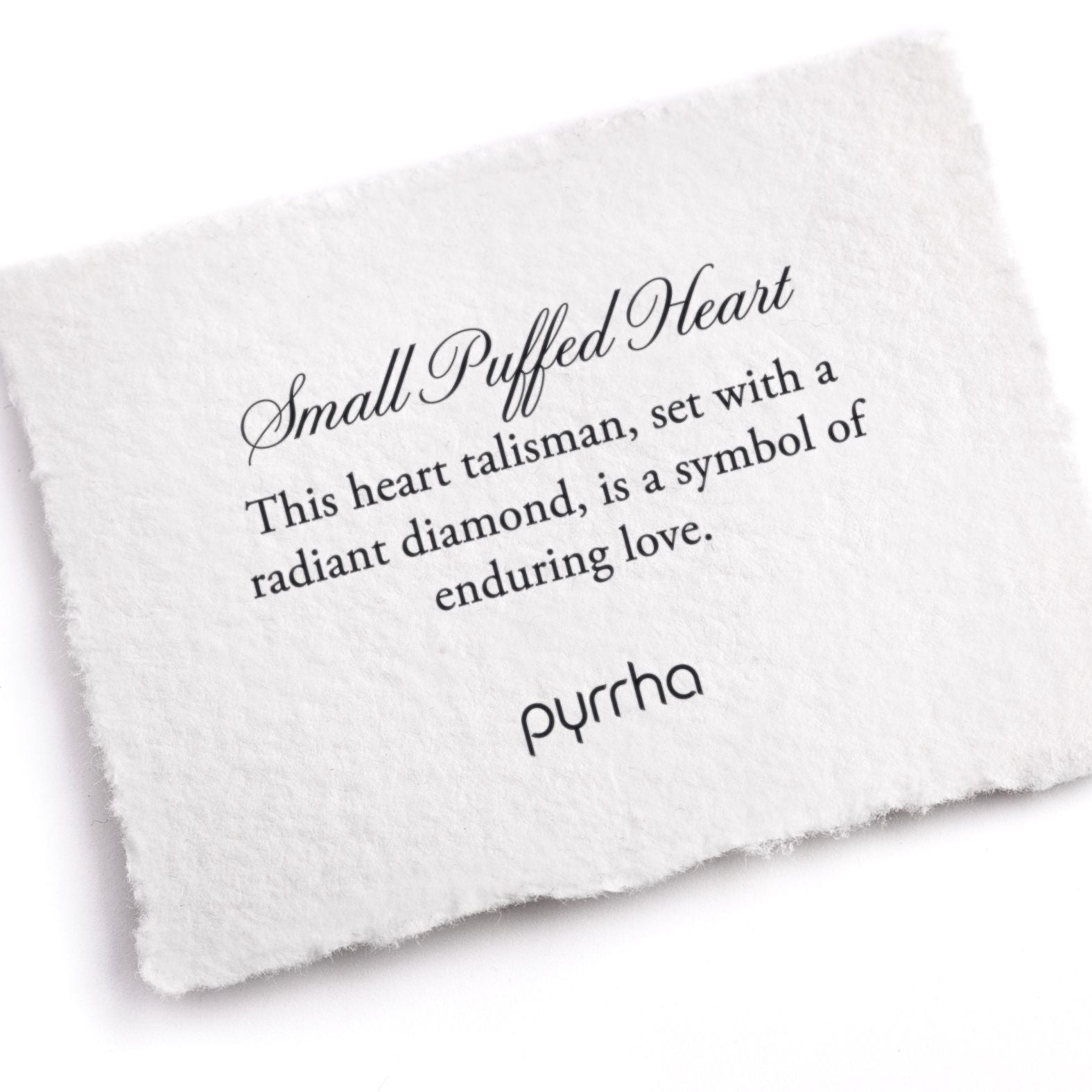 A hand-torn, letterpress printed card describing the meaning for Pyrrha's Small Puffed Heart Talisman
