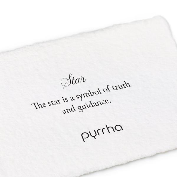 A hand-torn, letterpress printed card describing the meaning for Pyrrha's Star Signet Ring